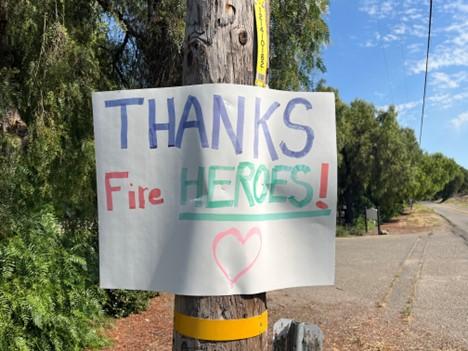 Thank you Firefighters signs on a power pole.