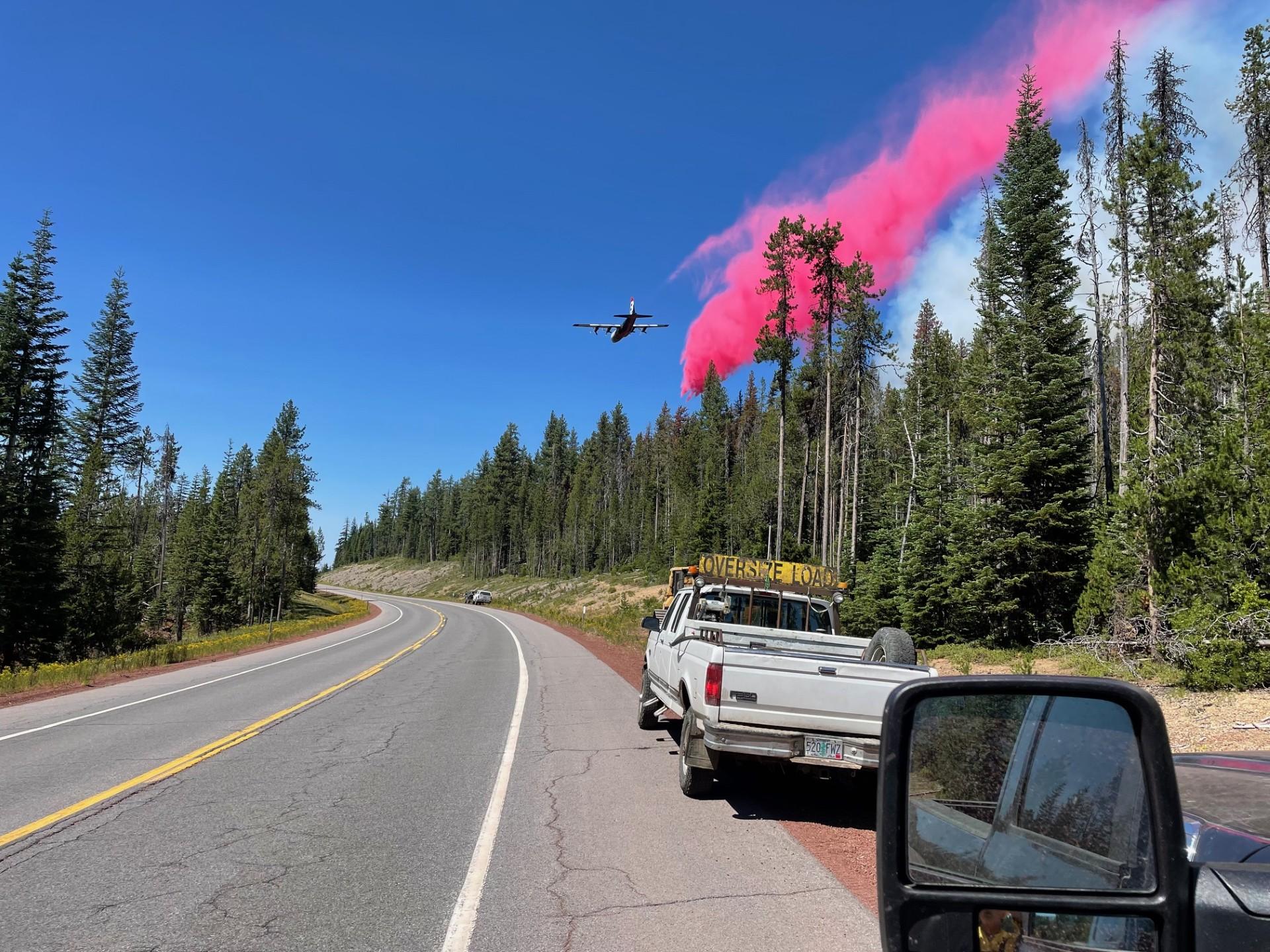 Photo of a plan dropping retardant on the Trail Fire during initial attack