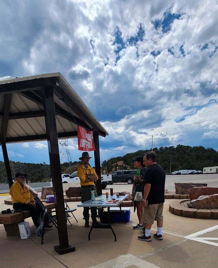 Speirs Fire Information Officers staffing a booth to answer questions and provide updates to the public.