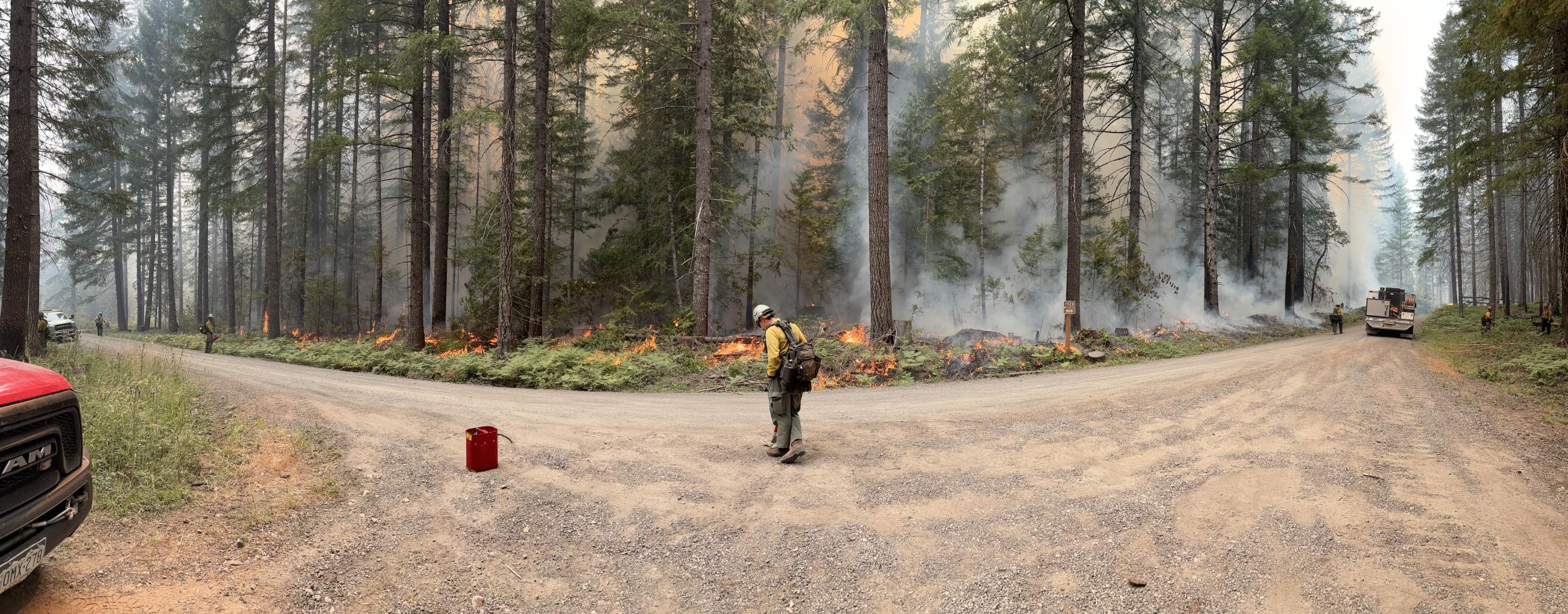 firefighters are spaced out along coffeepot fireline to ensure it does not cross to other side