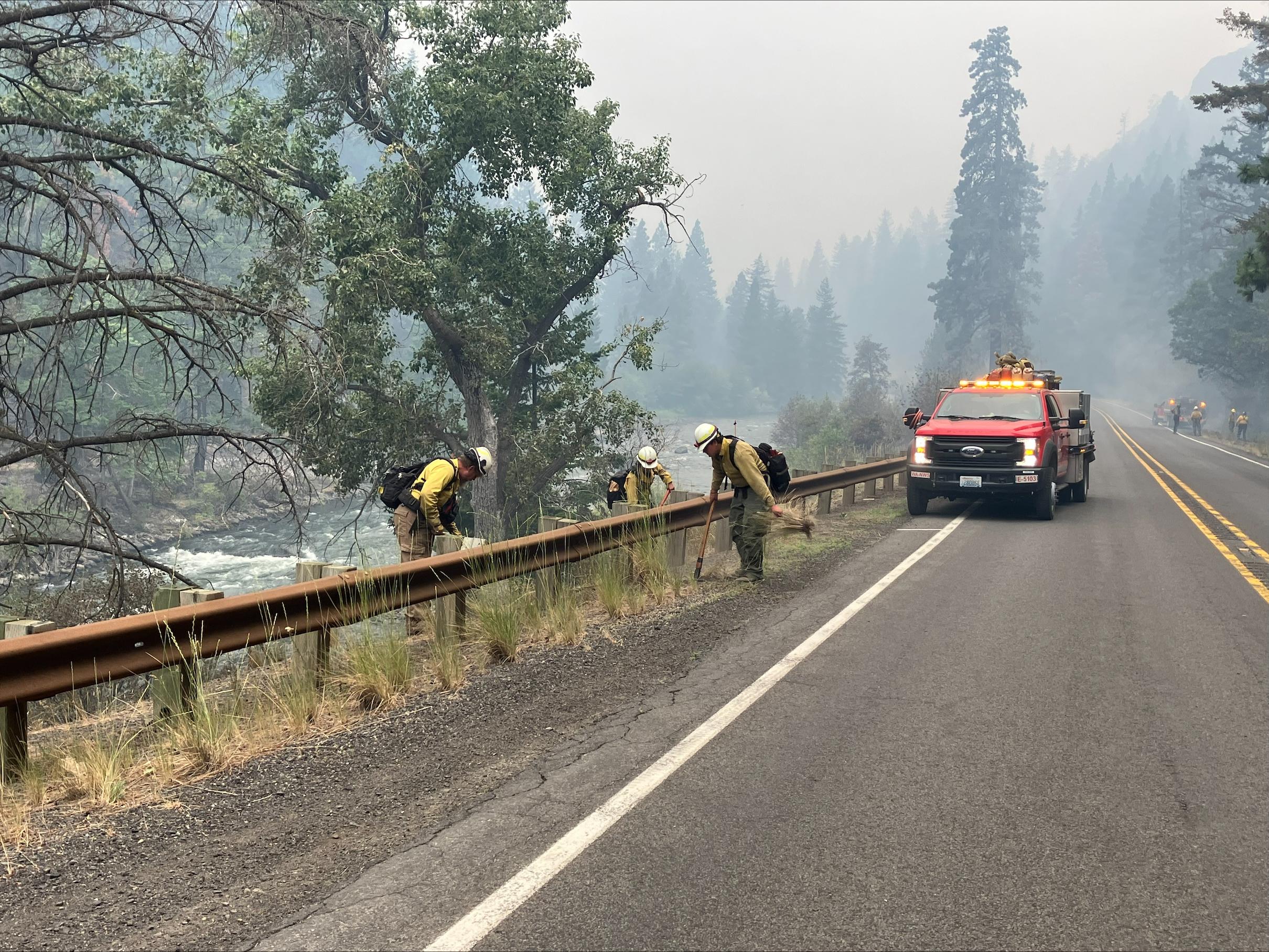 Firefighter standing on Highway near a guard rail 