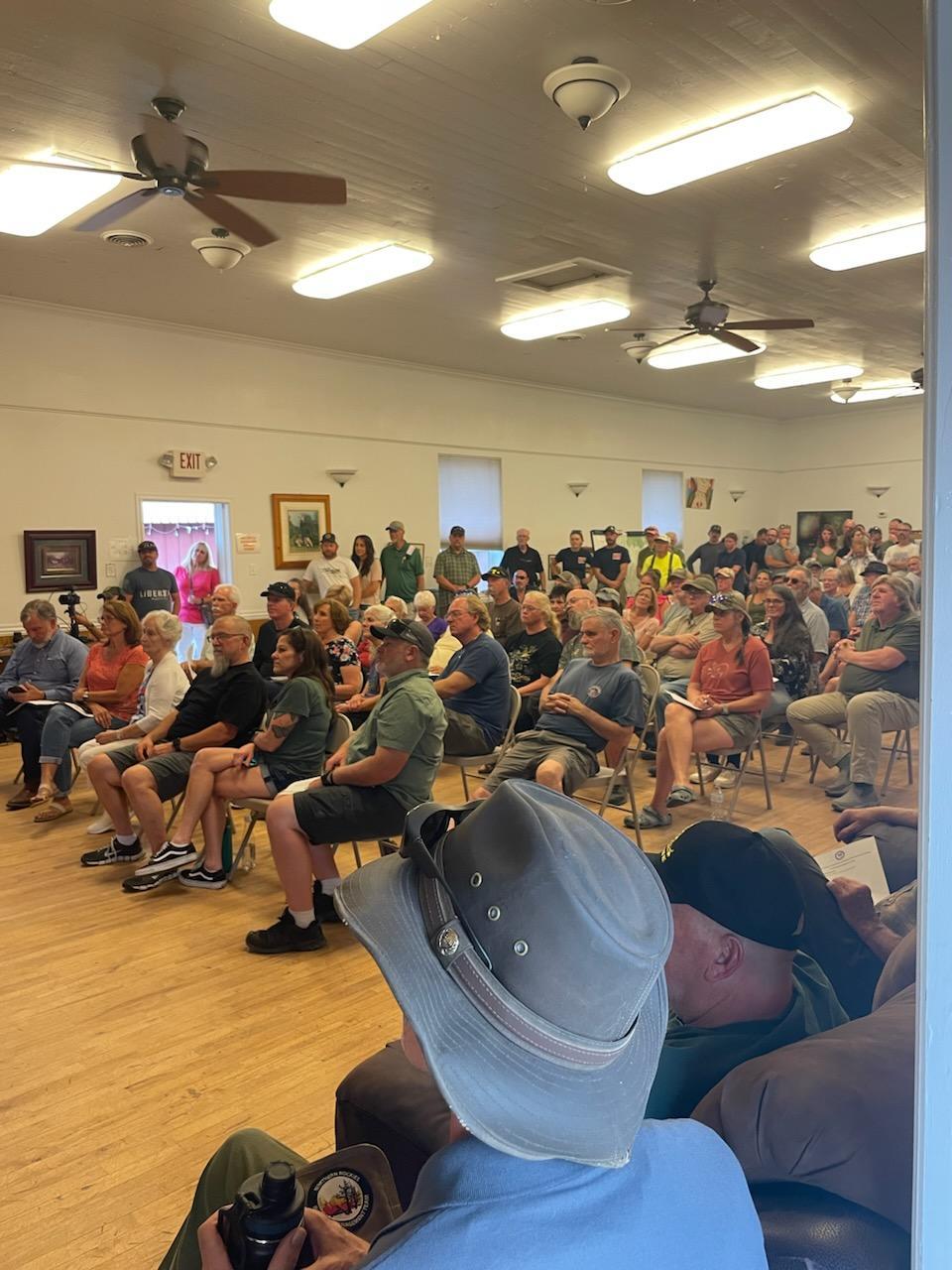 Community members seated at the community meeting in Crouch