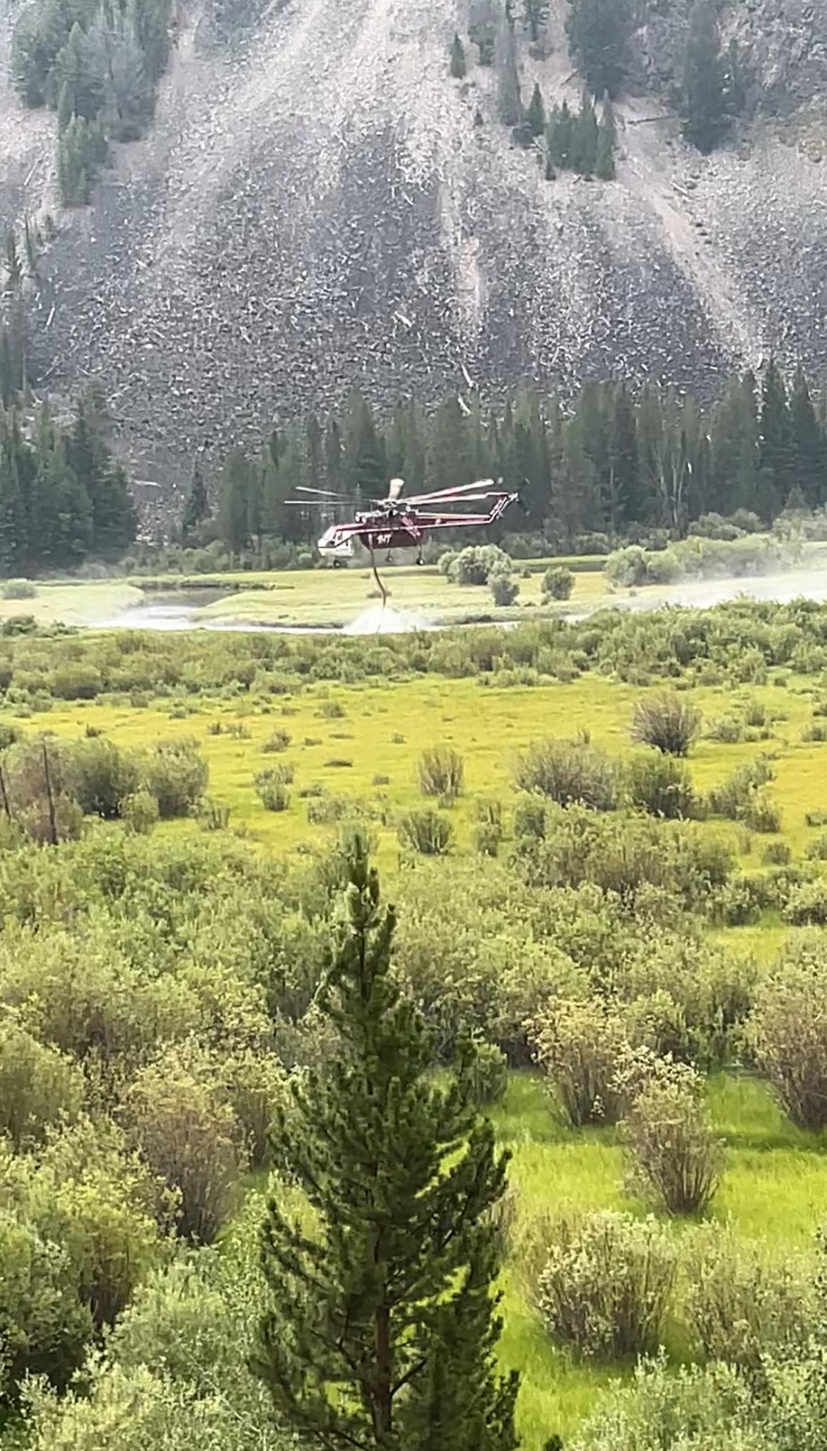 Photo of a Type 1 helicopter, a Sikorsky (skycrane) dipping out of the Pettengill Creek on the Grouse Fire, southwest of Wise River, MT. Photo by G. Campbell.