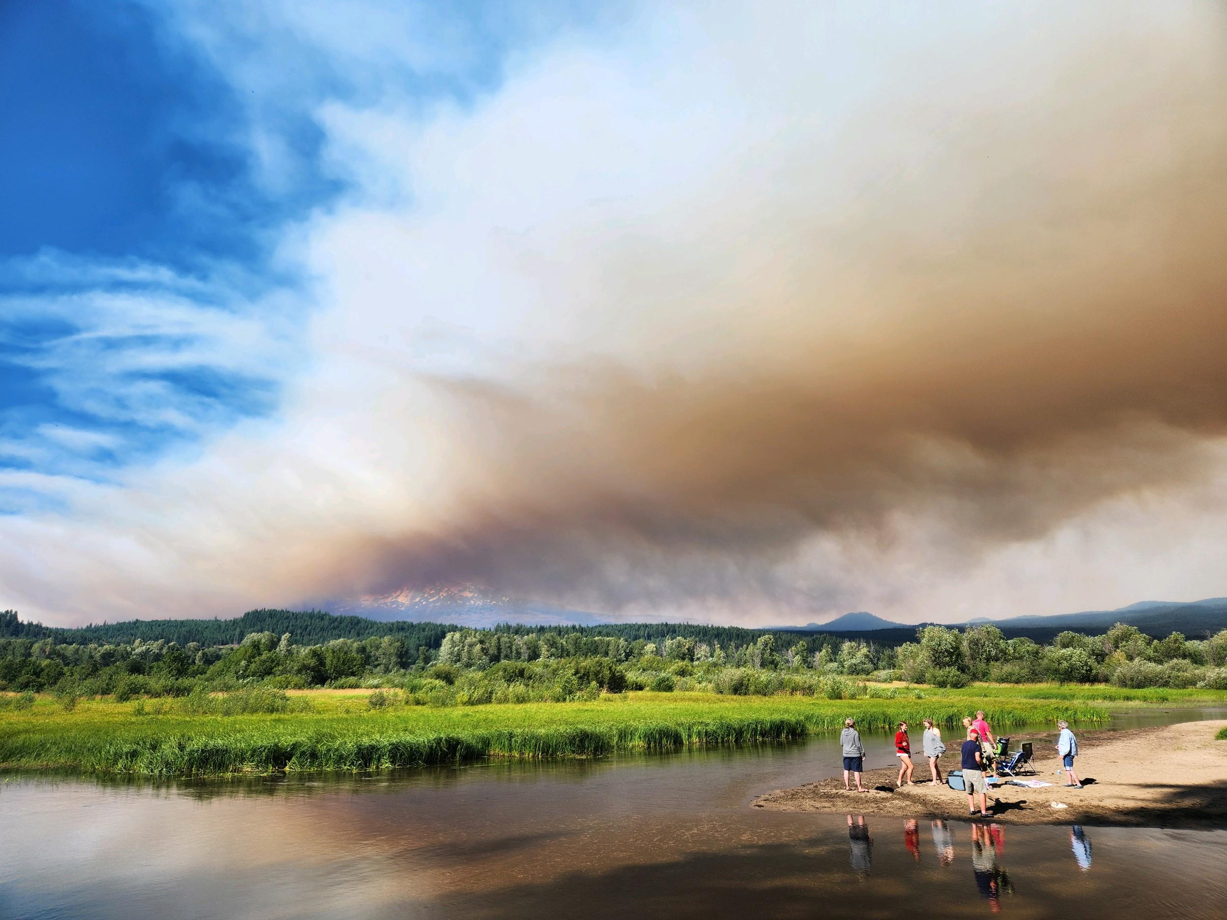 Image of brown wildfire smoke blowing across the horizon. 