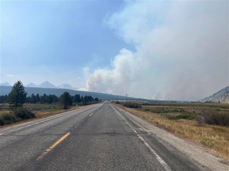 smoke rises in distance  along Hwy 21 seen from Stanley Area, Afternoon August 26