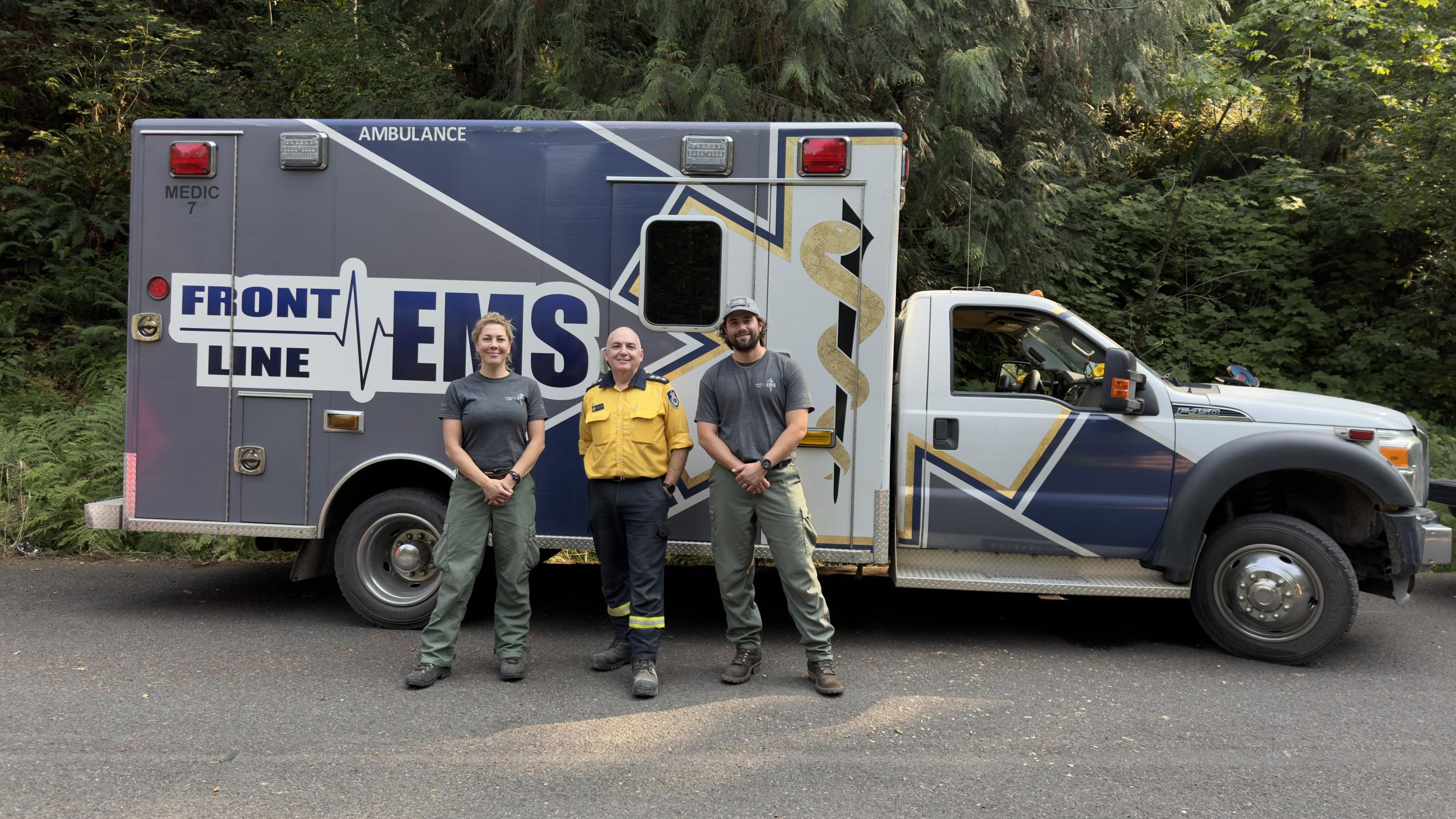 Ambulance with people standing by