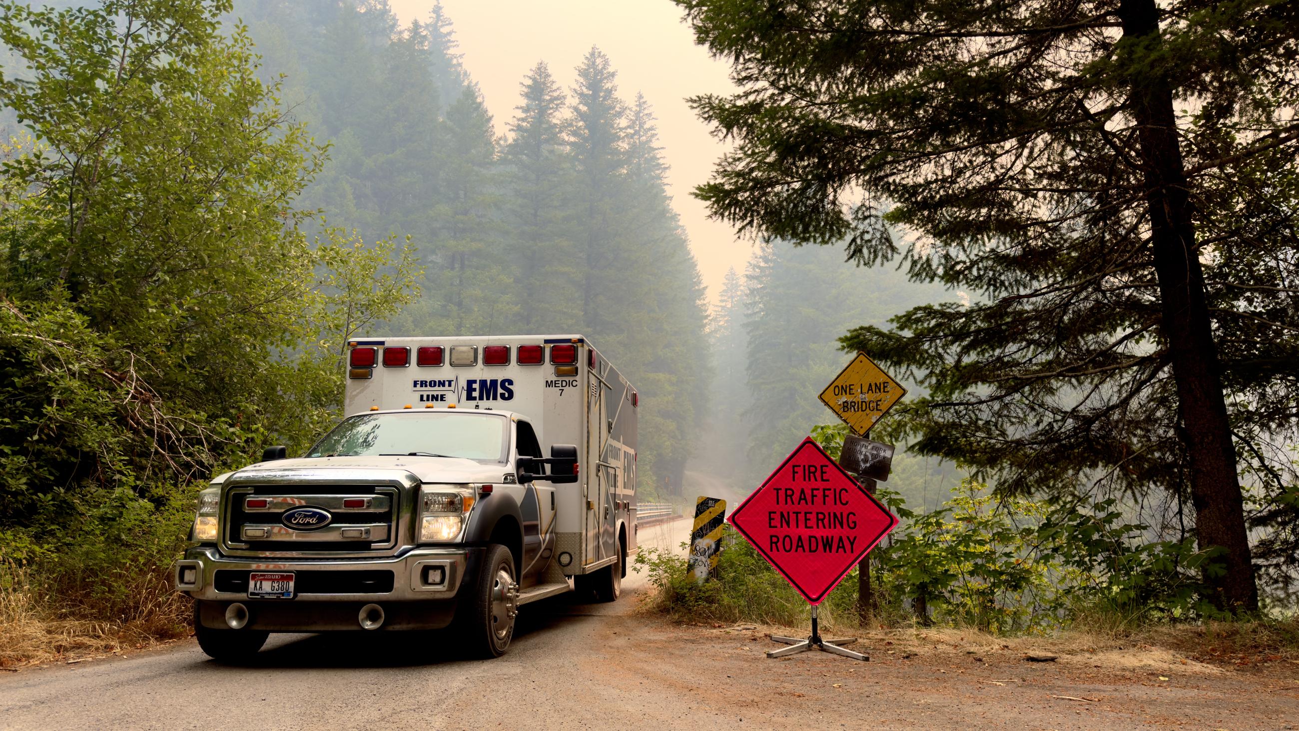 Ambulance by fire sign in smoke