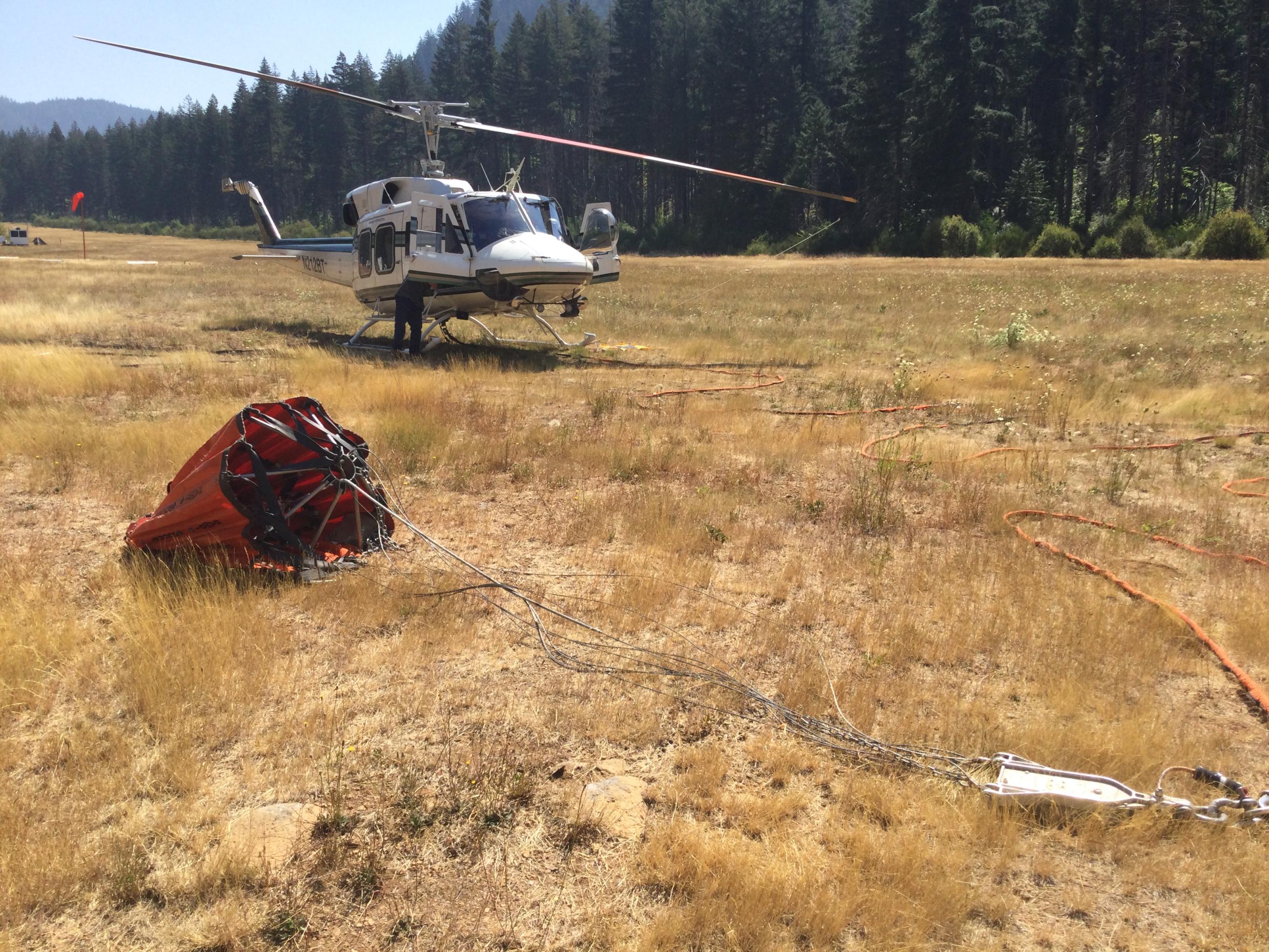 helicopter with bucket in front of at base