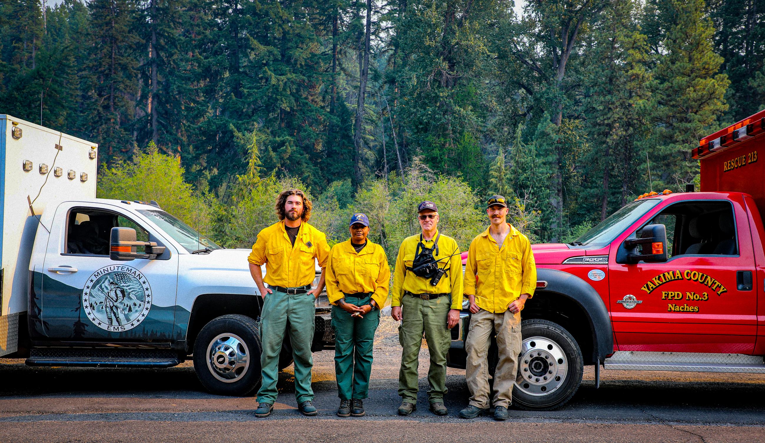 4 men standing near a truck 