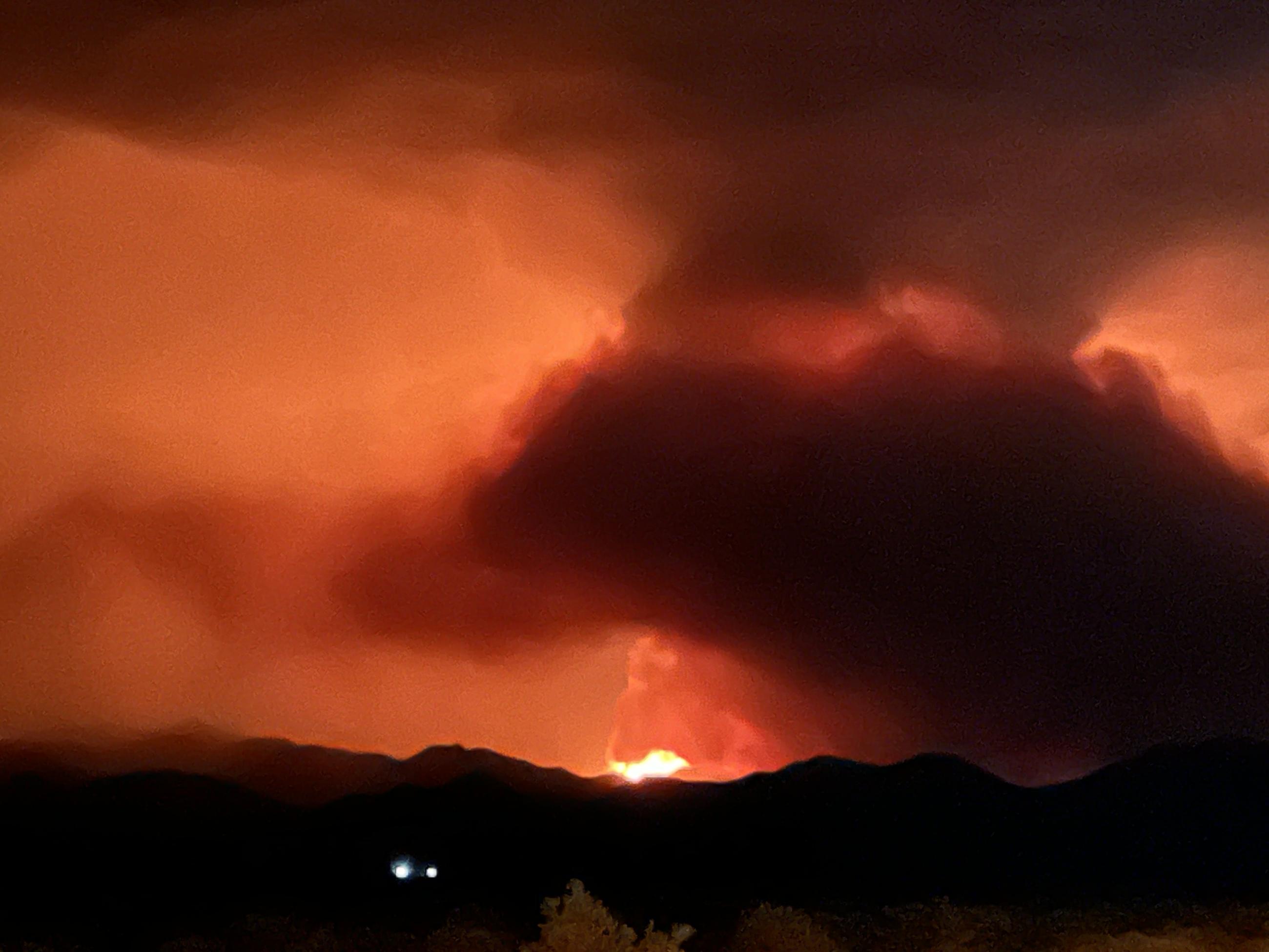 Distant view of Element Fire against nighttime skyline.