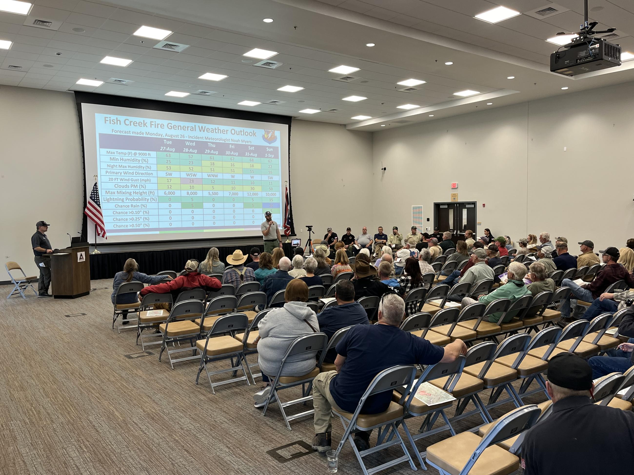 People sitting in the room for a public meeting 