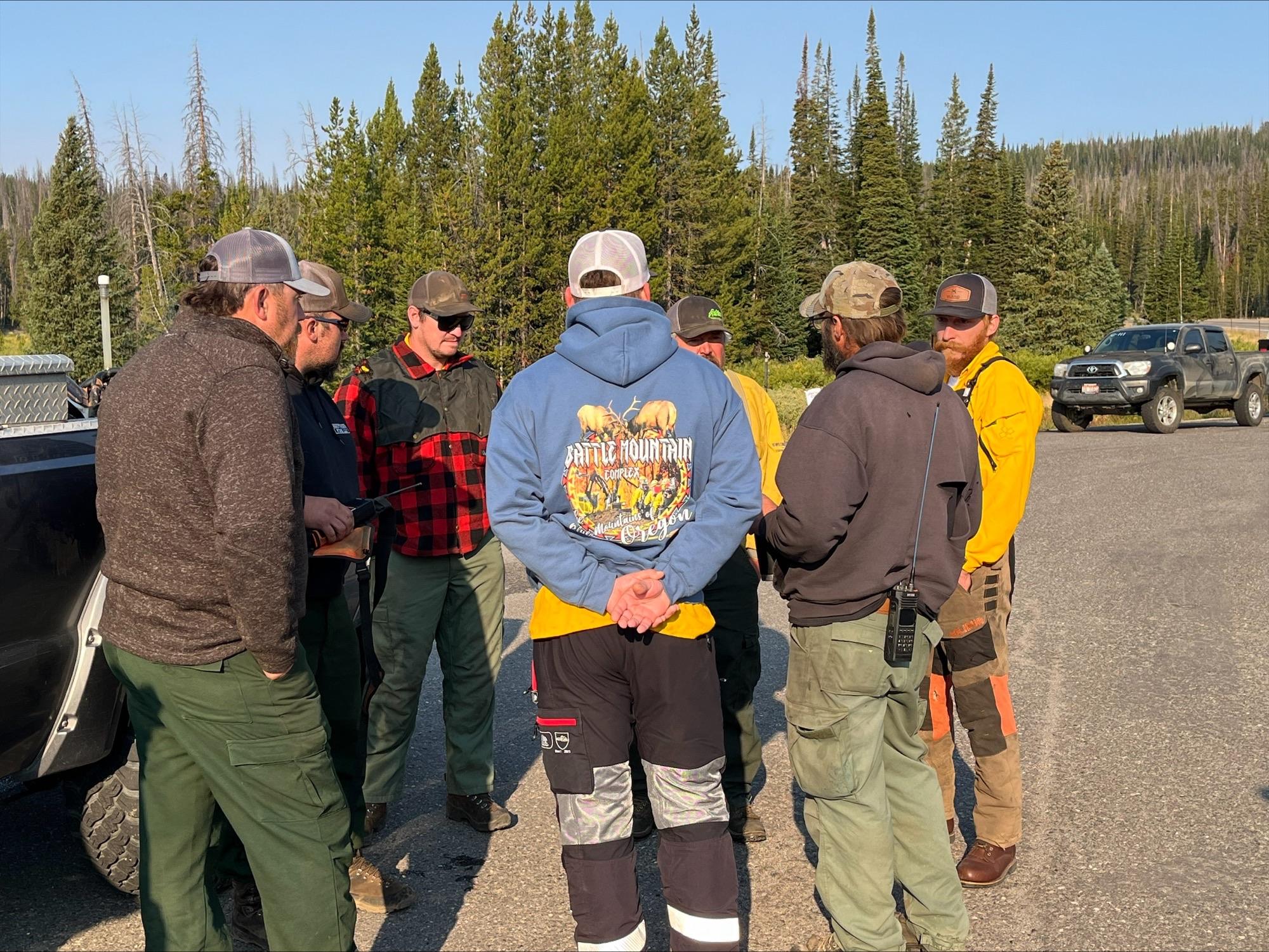 Sawyers conduct safety meeting before hazard tree mitigation