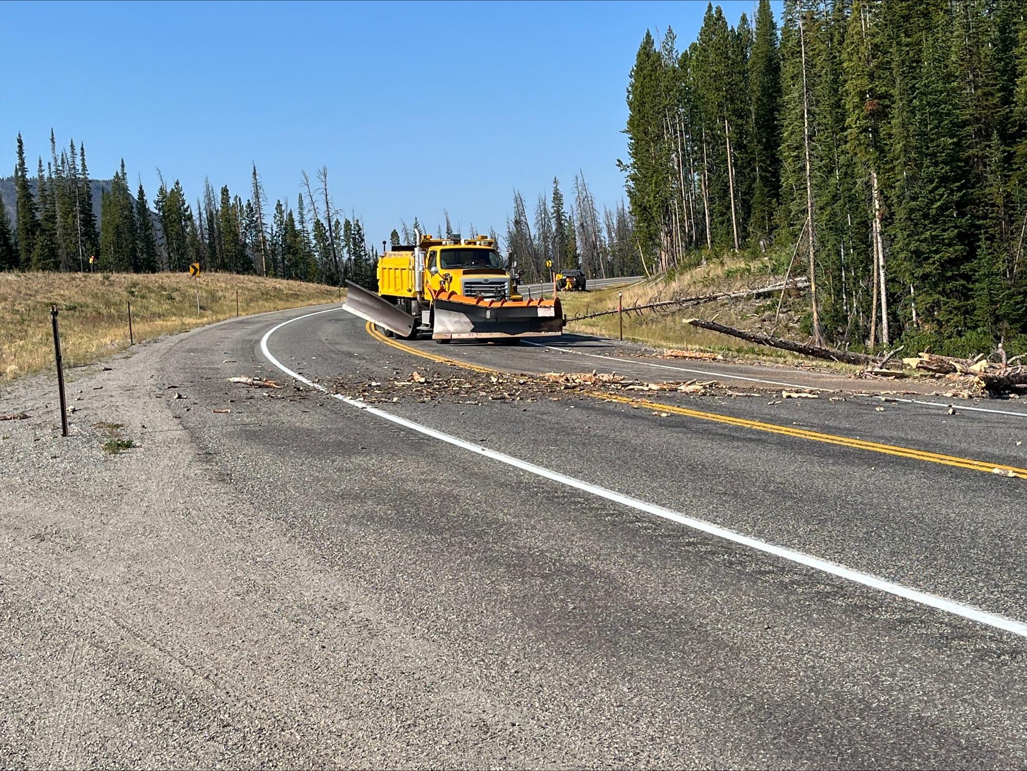 Wy DoT uses a snow plow to move hazard trees off HWY 26 August 29, 2024