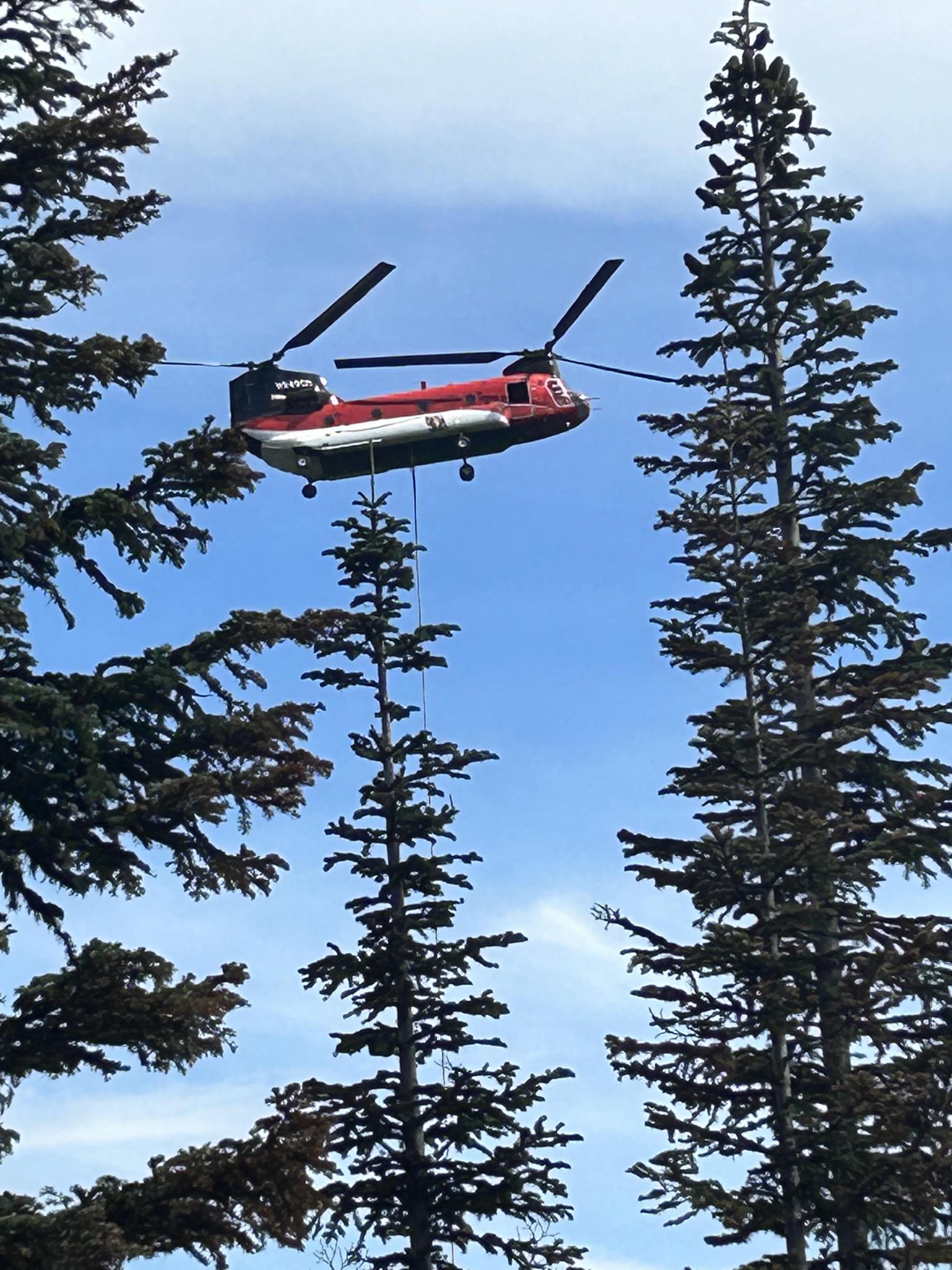 Large helicopter flys with bucket