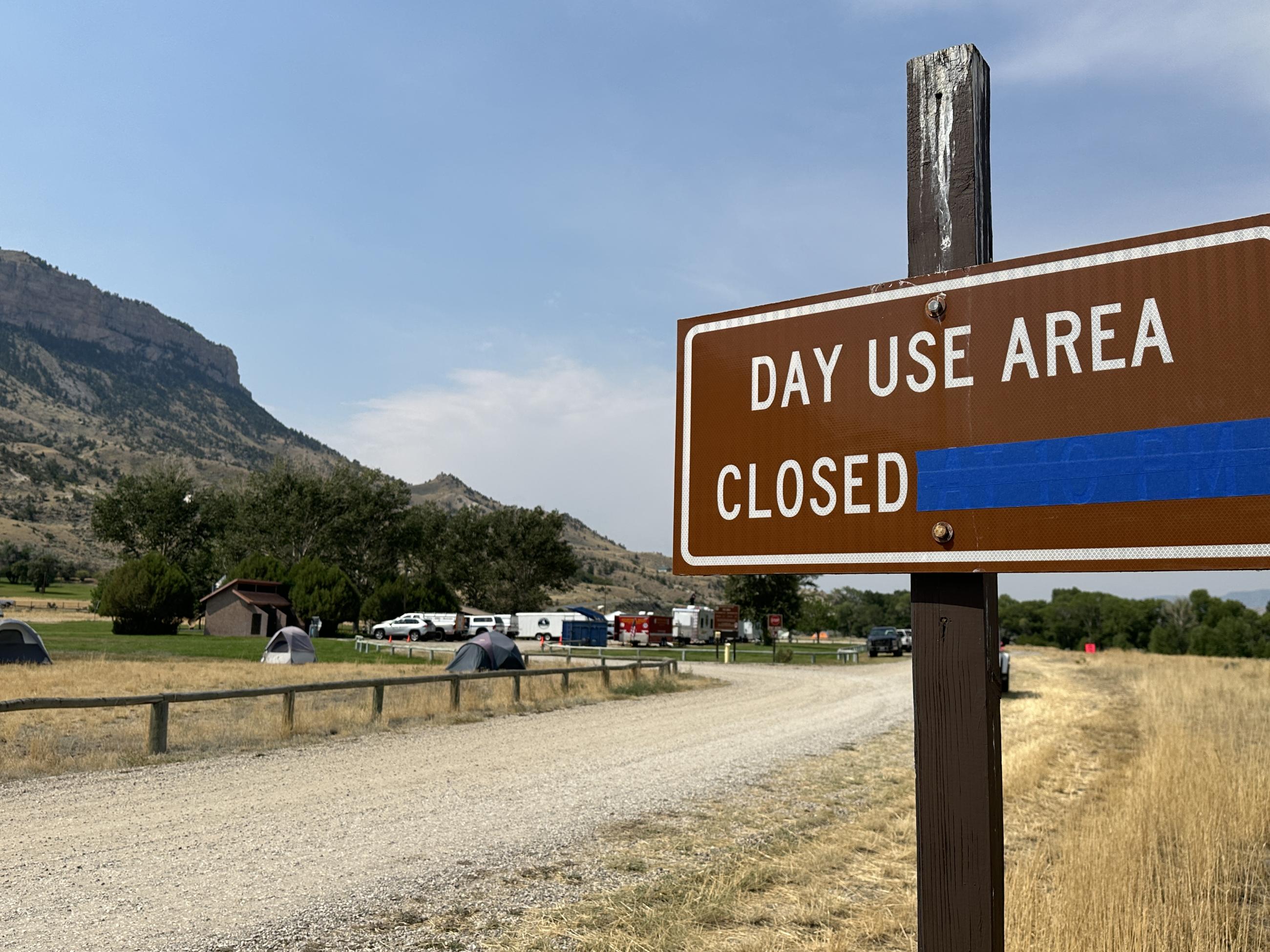 A brown state park sign notes the day use area is temporarily closed.