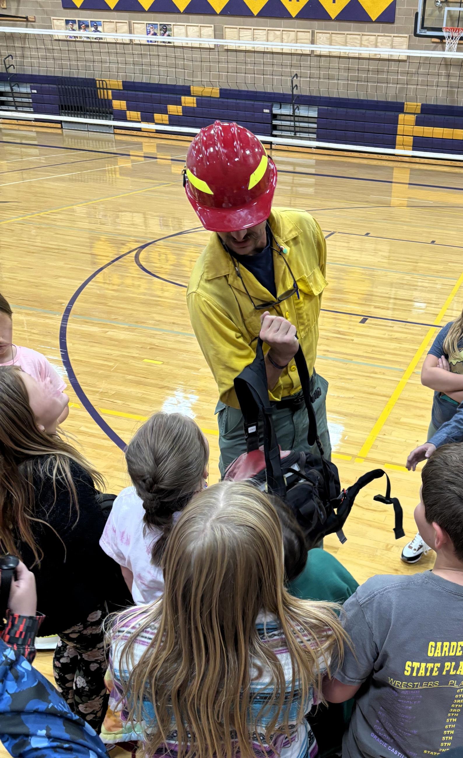 Students at Garden Valley School explore a firefighter pack and gear.