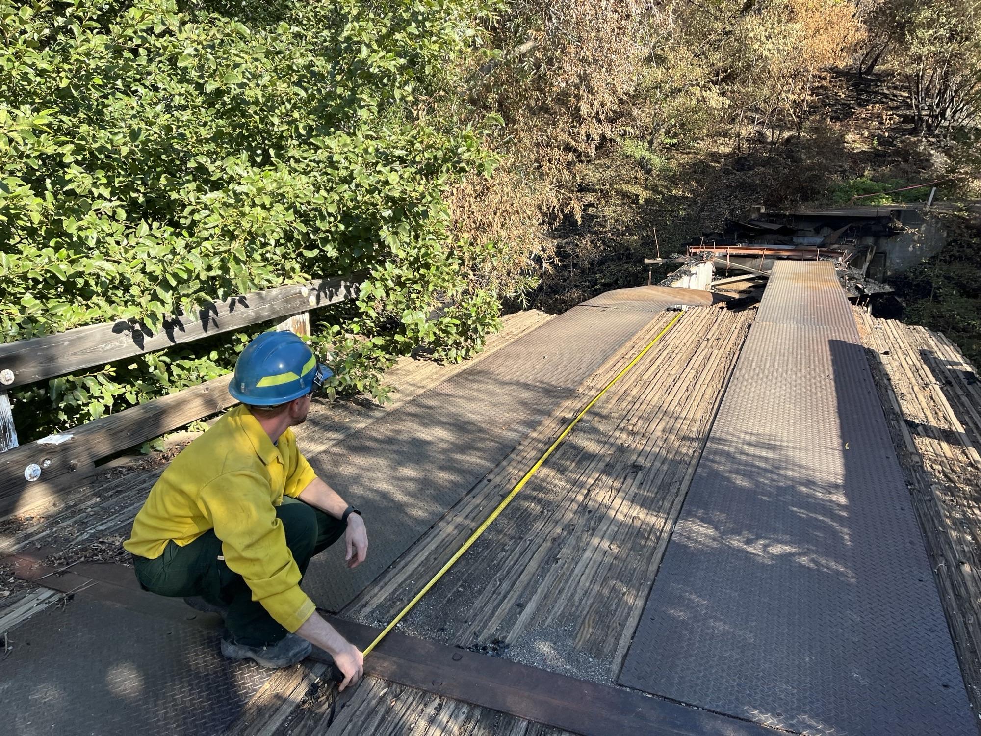 Image showing BAER Engineer Todd Orange Assessing Black Rock Bridge Damaged in Park Fire