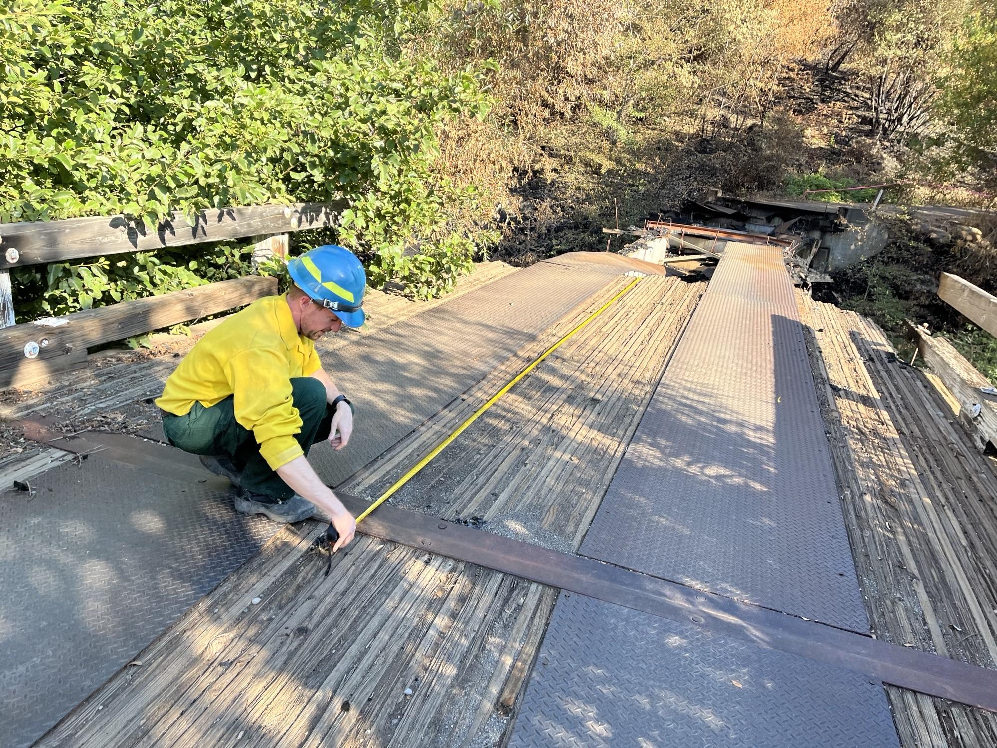 Image showing BAER Engineer Todd Orange Assessing Black Rock Bridge Damaged in Park Fire