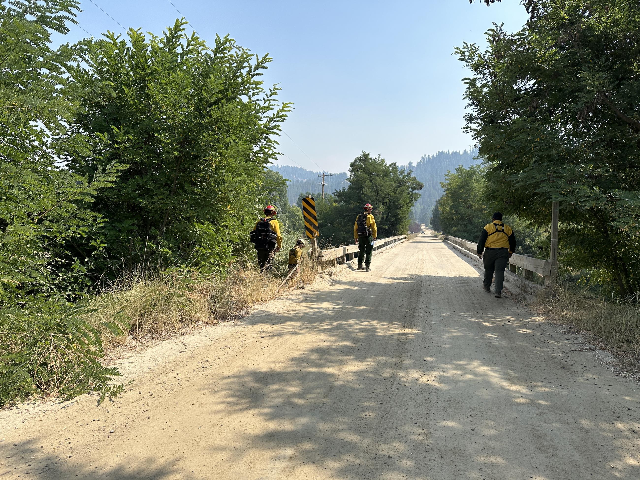 Crew members from E191 Outback (UT) assess a bridge to ensure it could handle the size and weight of a variety of firefighting vehicles.