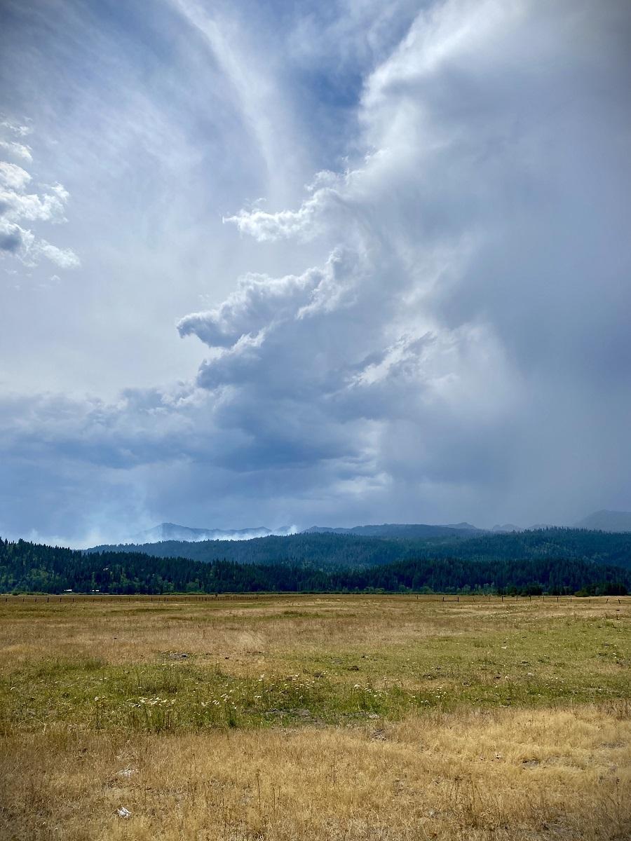 Smoke from fire and clouds from thunderstorm