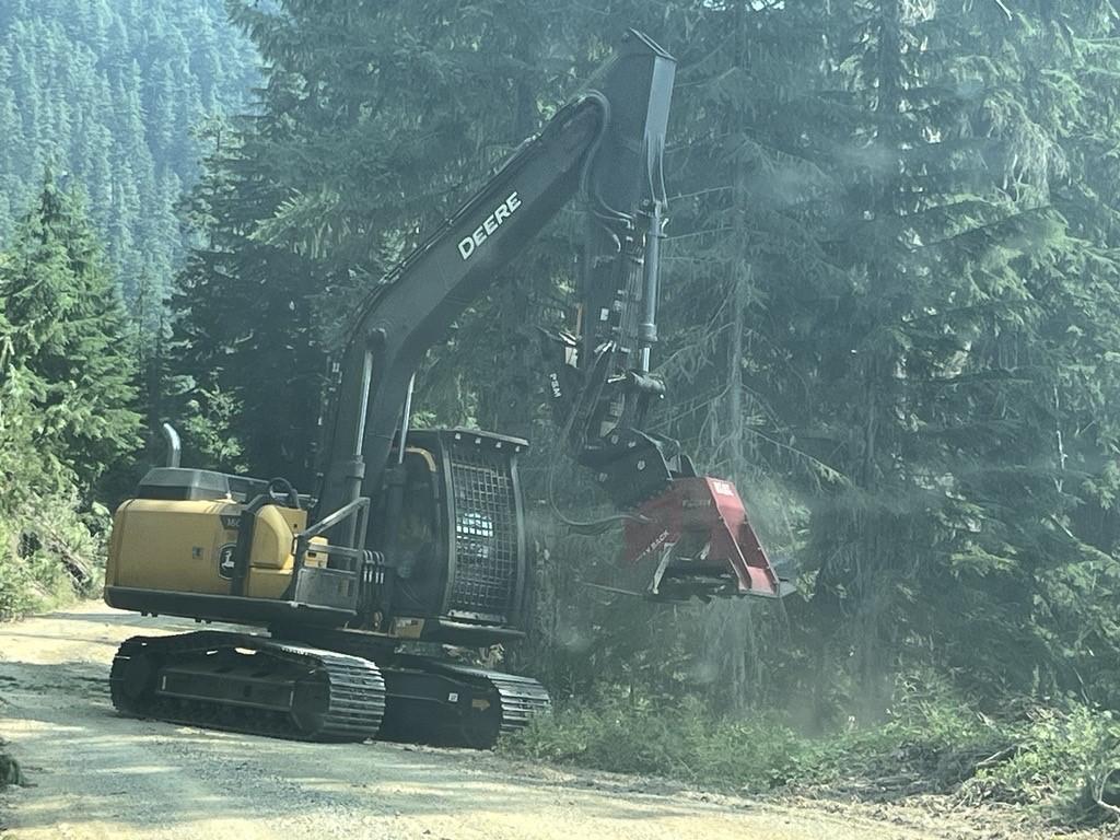 photo showing heavy equipment securing line on fire