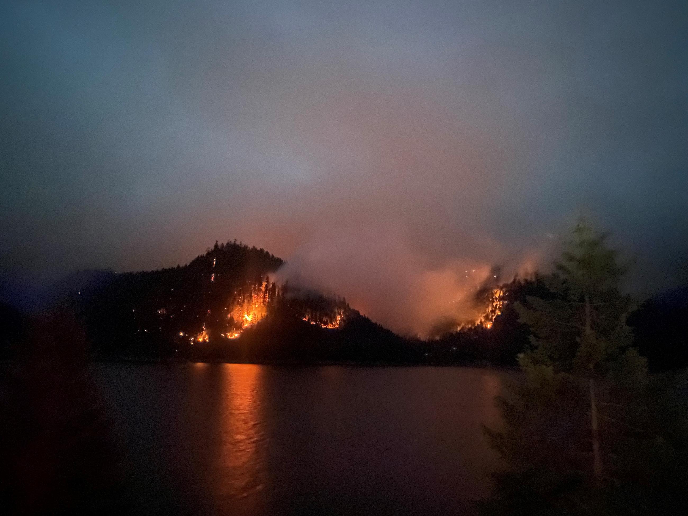 coffeepot fire burns actively at night near the lake