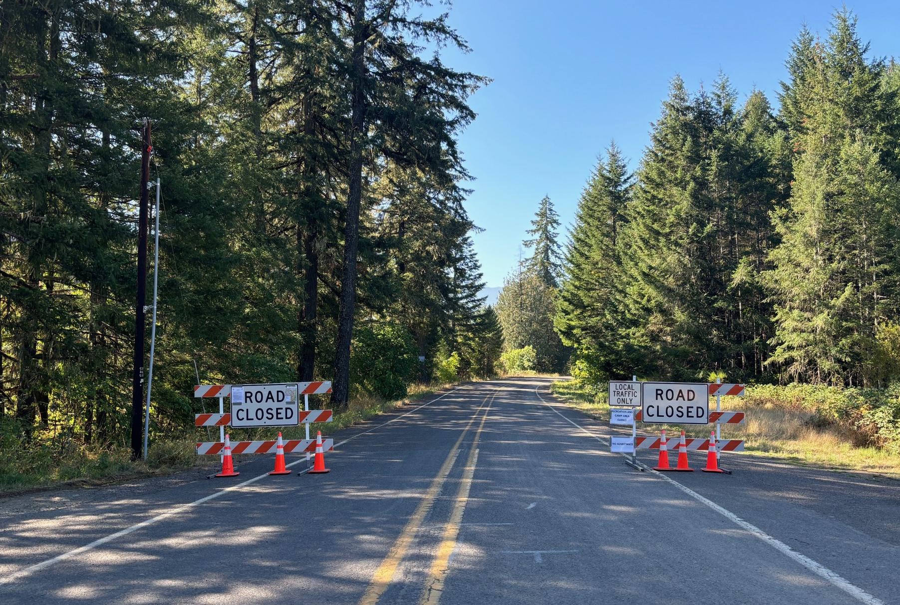 This photograph shows barriers on a road closed to the public.