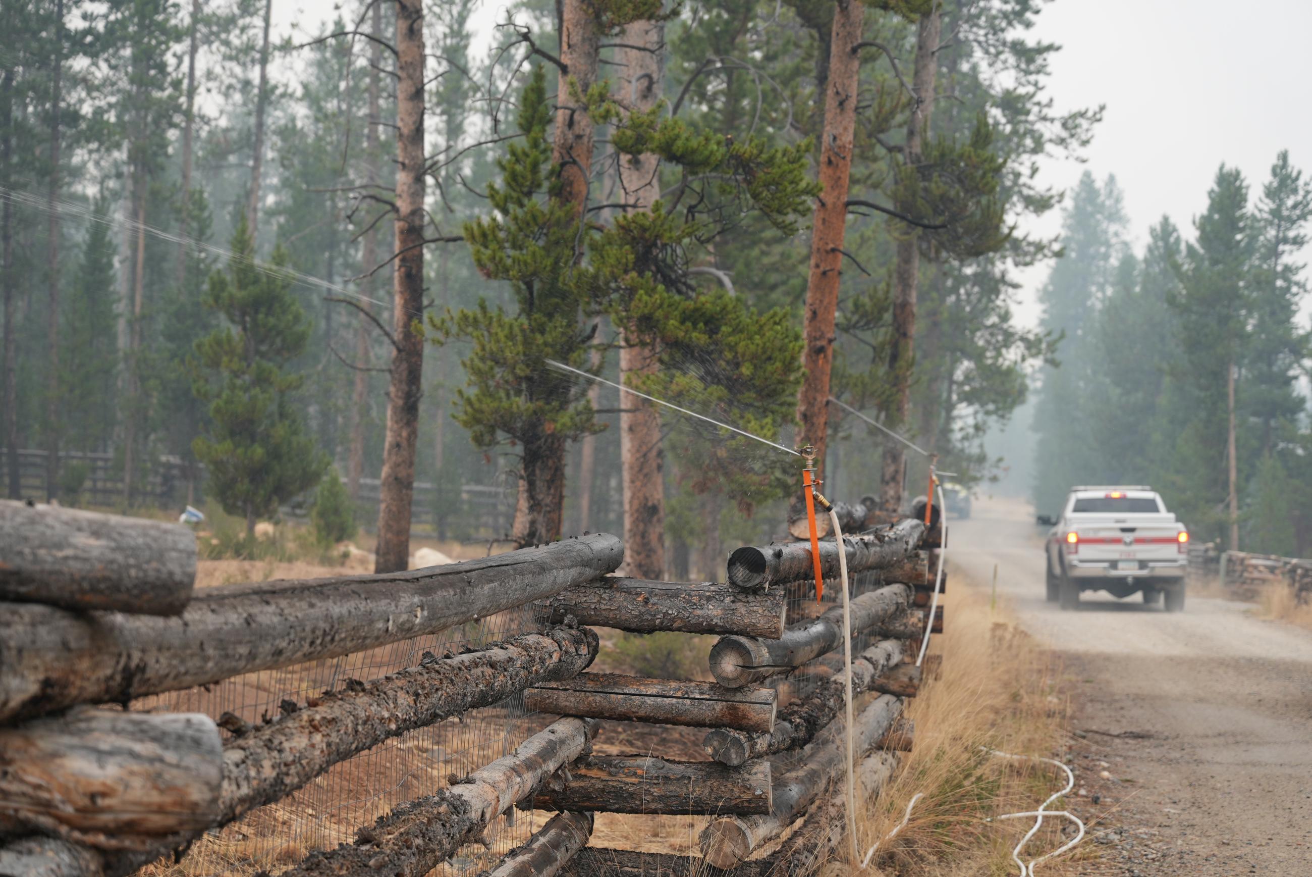 Sprinklers Installed on a fence and Operating in Iron Creek Subdivision, Thursday, August 29