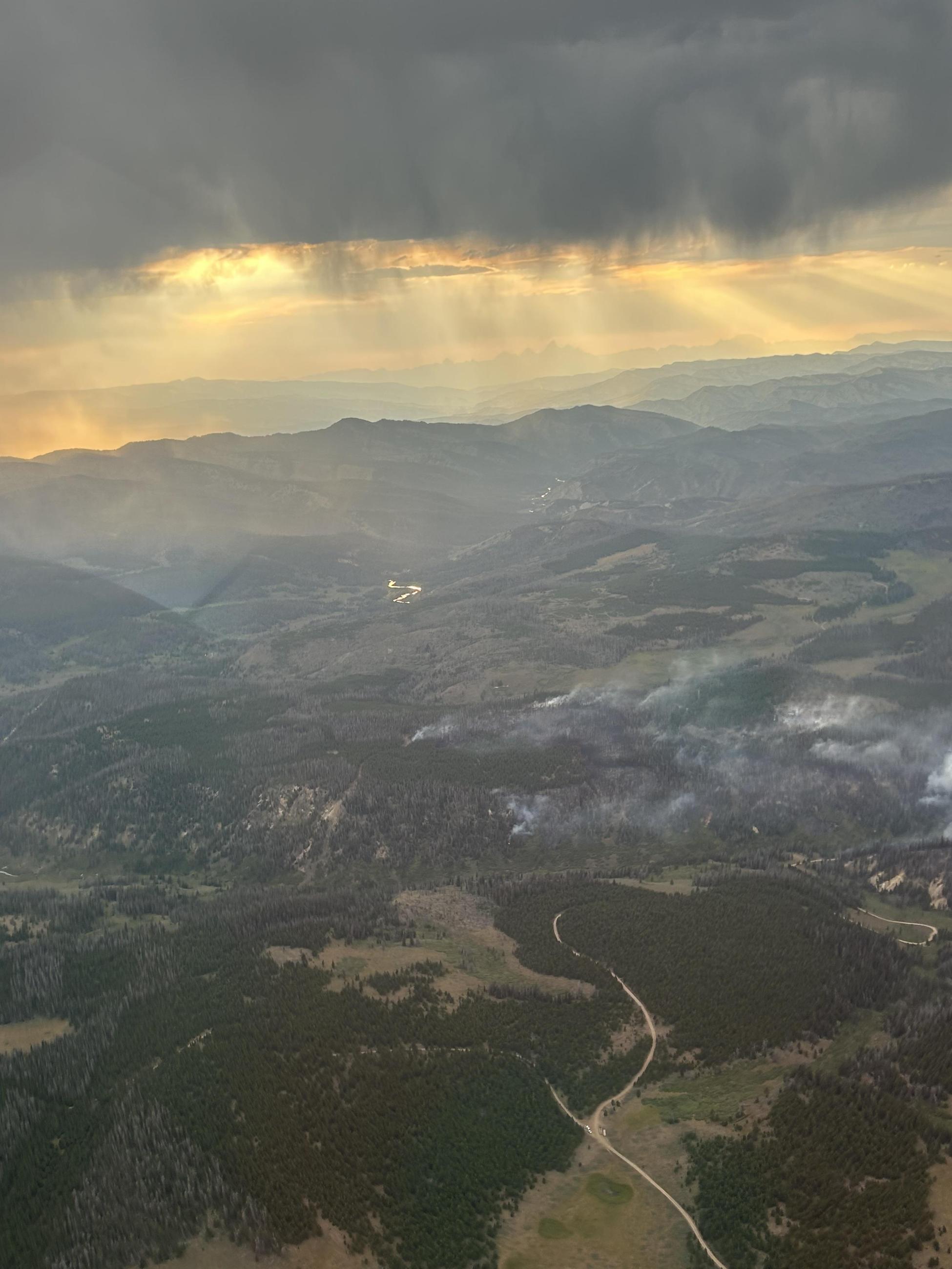 Aerial view of smoke from Leeds Creek Fire with incoming rain clouds