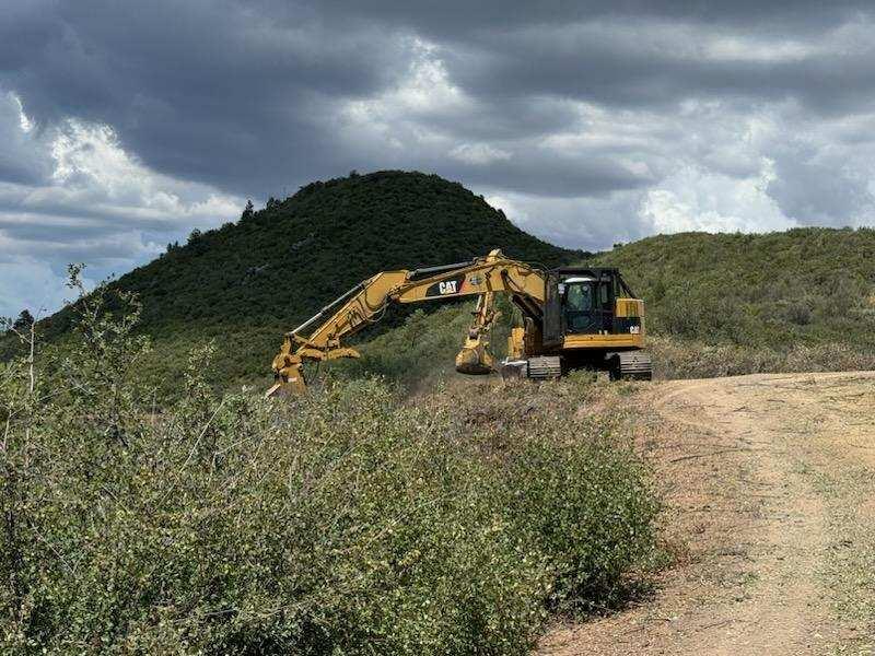 Heavy machinery clearing brush on the 201 Forest Road