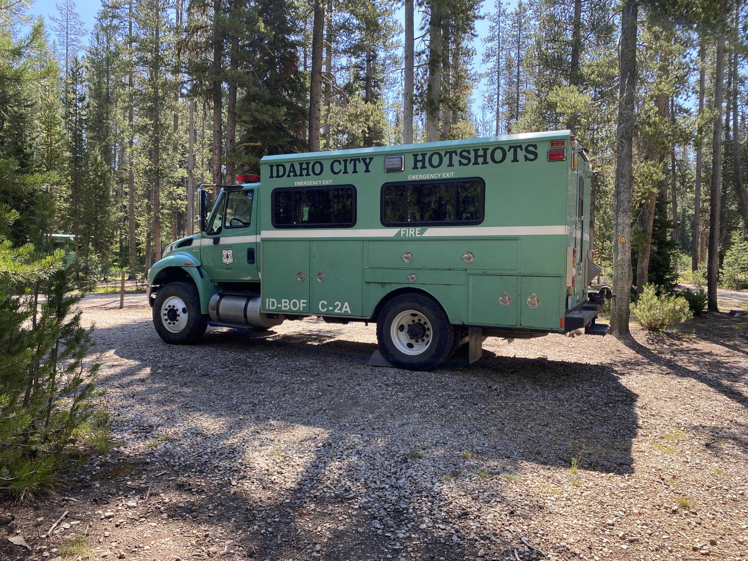 Big green truck sitting in woods