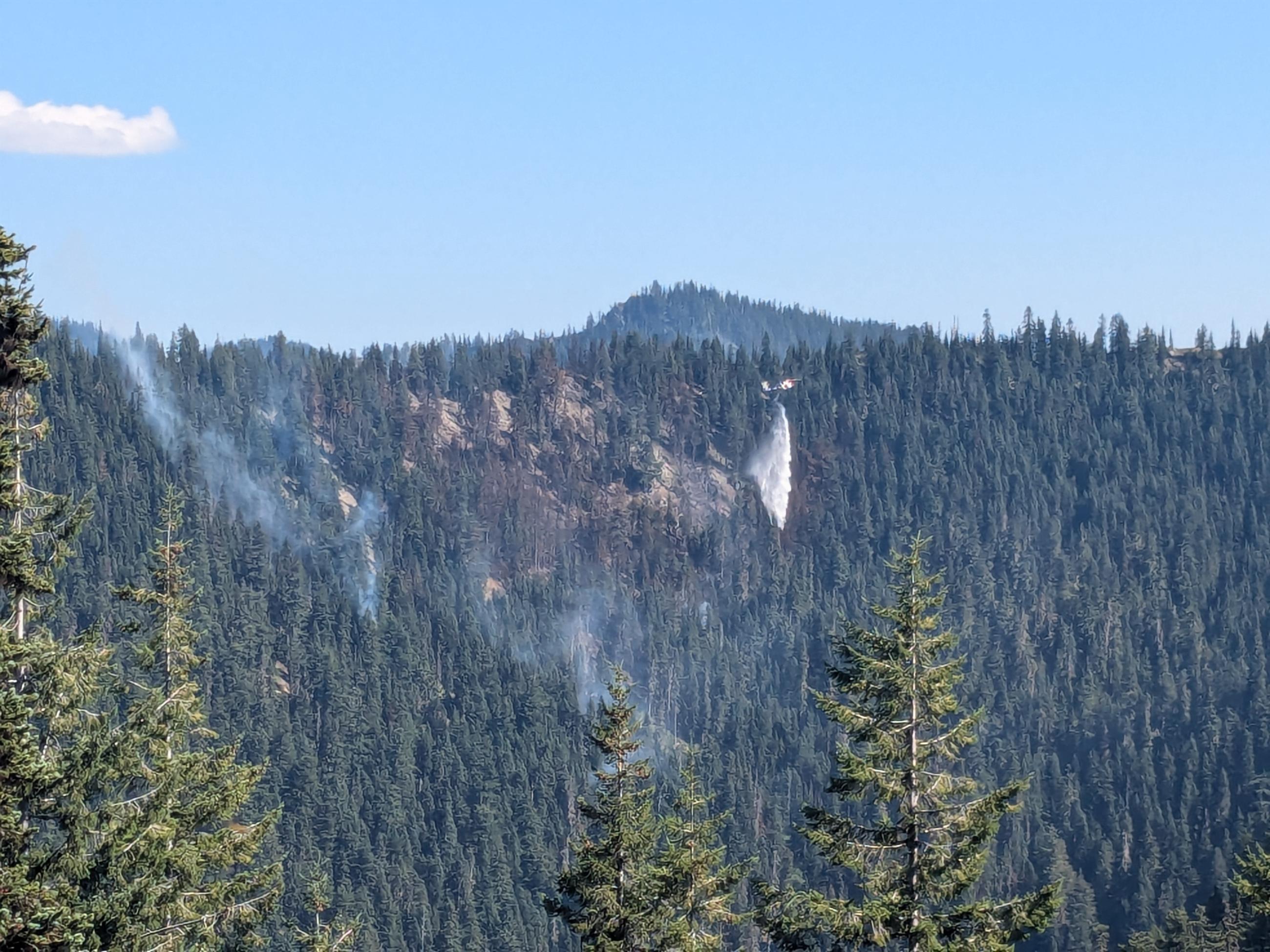 Helicopter drops water on a fire