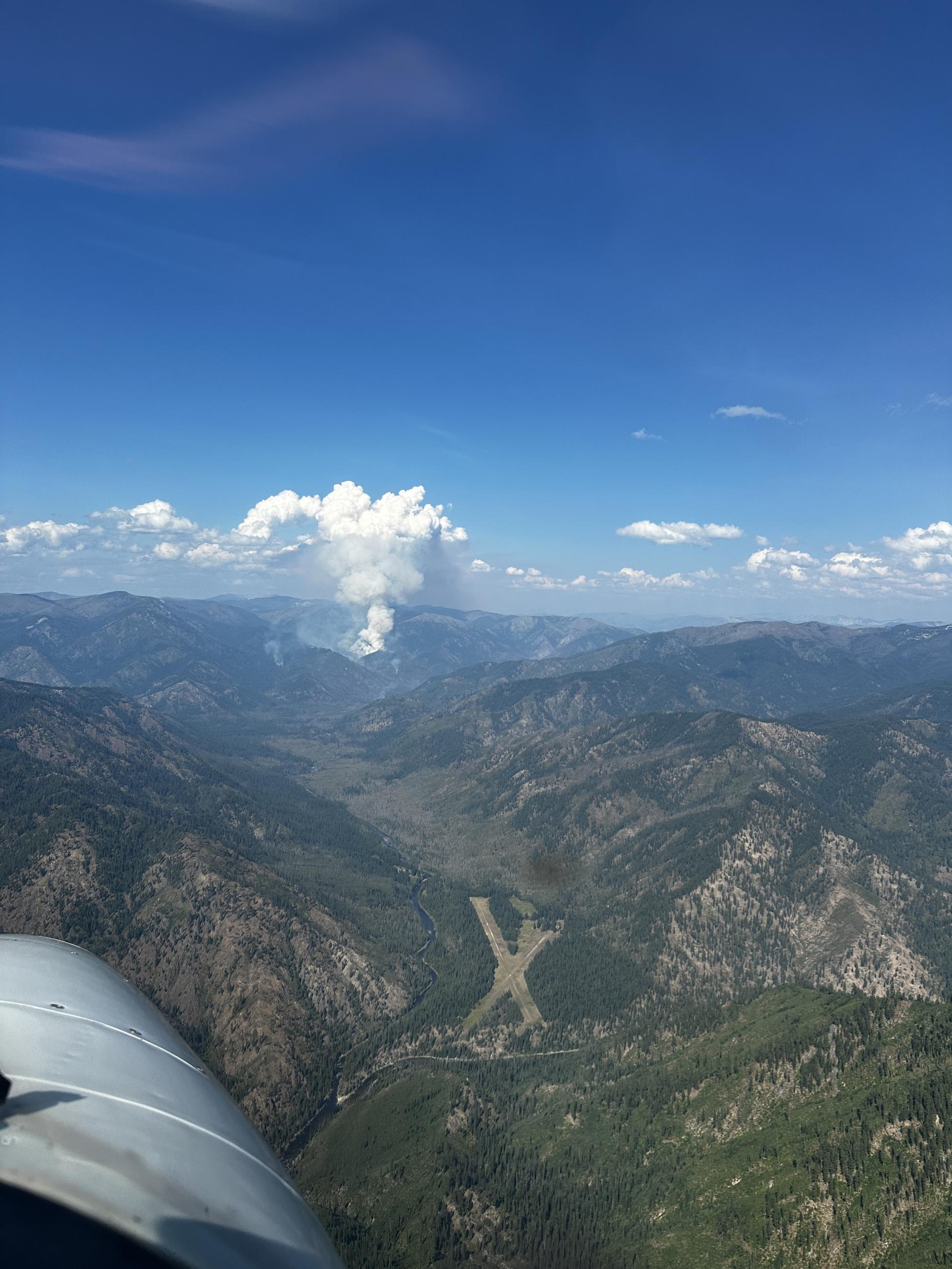 Wye Fire putting up a sizable smoke plume. Moose Creek Air Strip in the foreground of the photo.