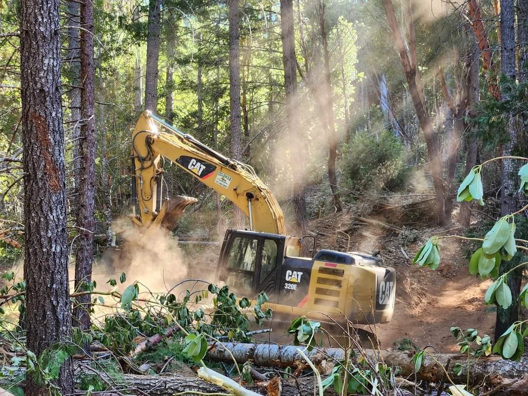 Excavator completing suppression repair on dozer lines