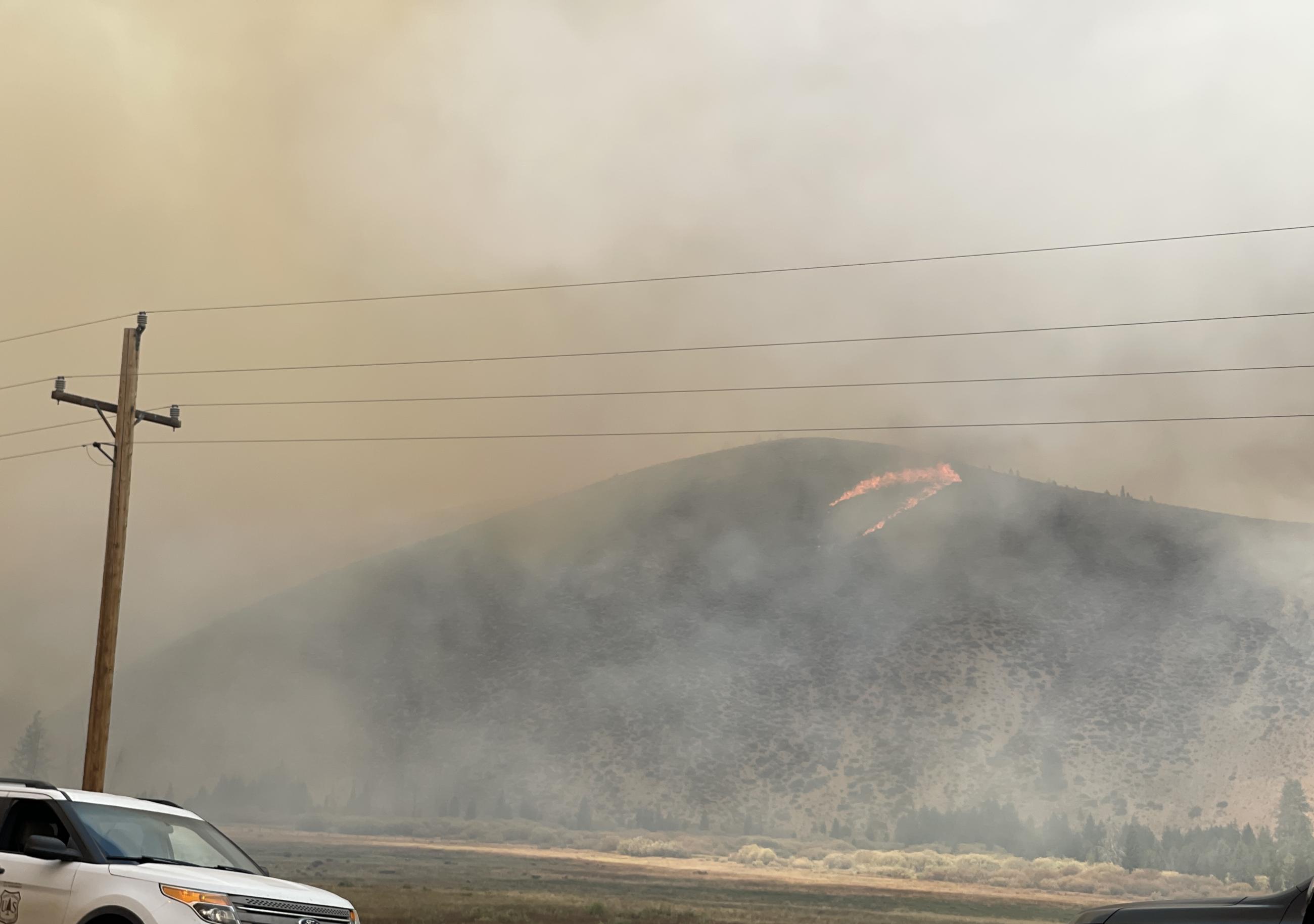 photo showing a small spot fire on hillside