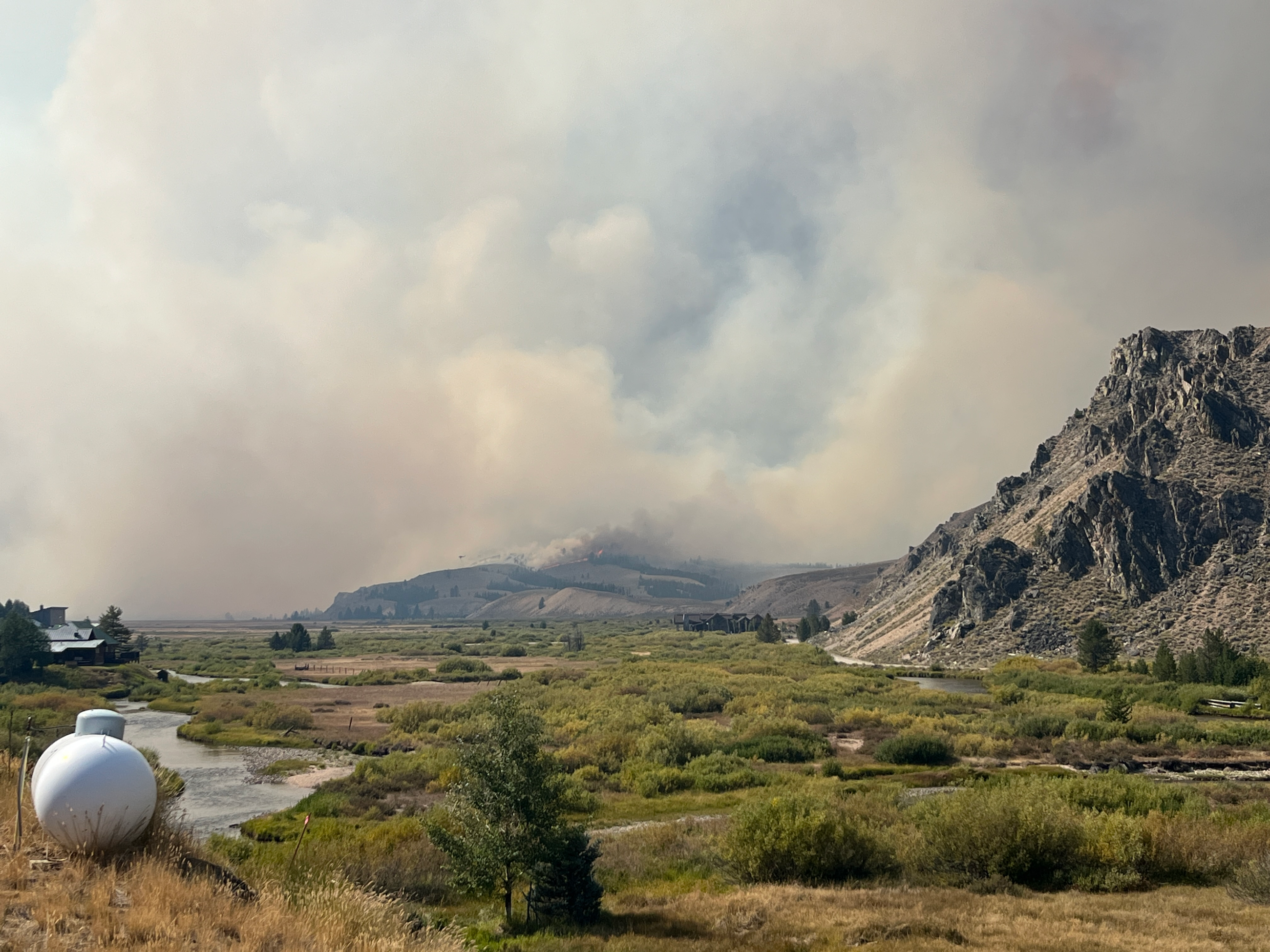 Wildfire smoke billows off a fire