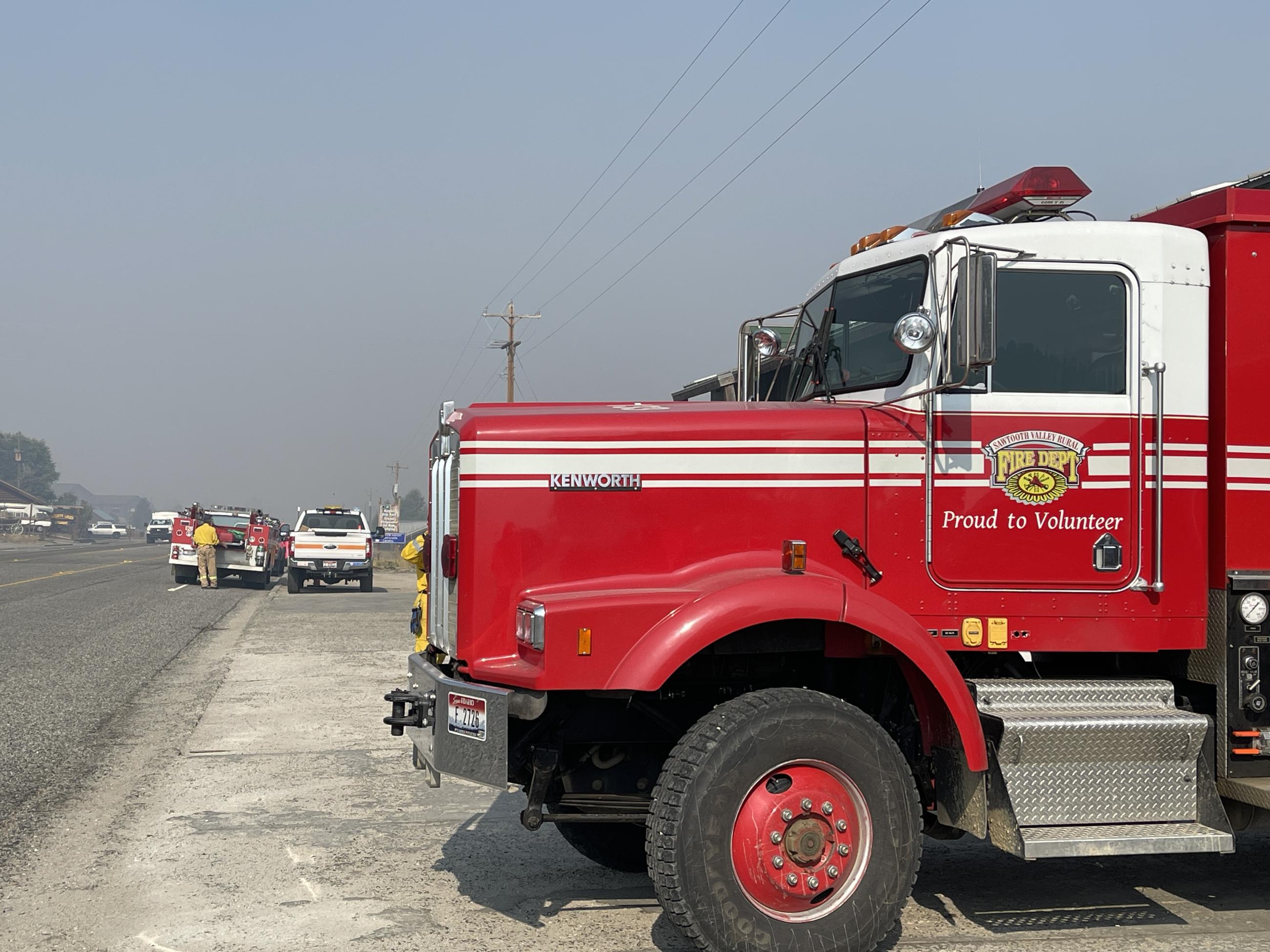 showing fire truck parked with smoky streets