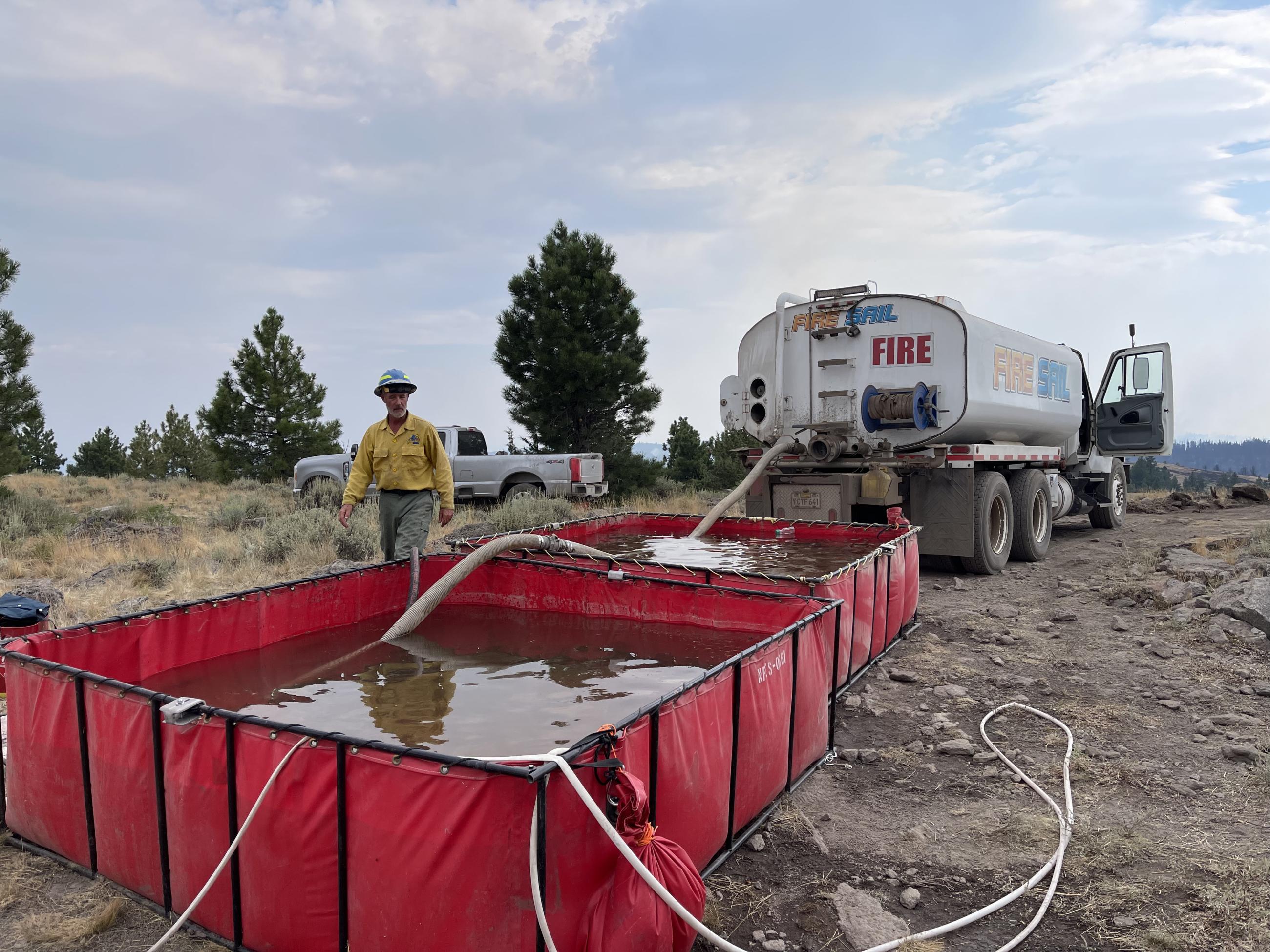 Water Tender filling up portable water tanks on the Falls Fire