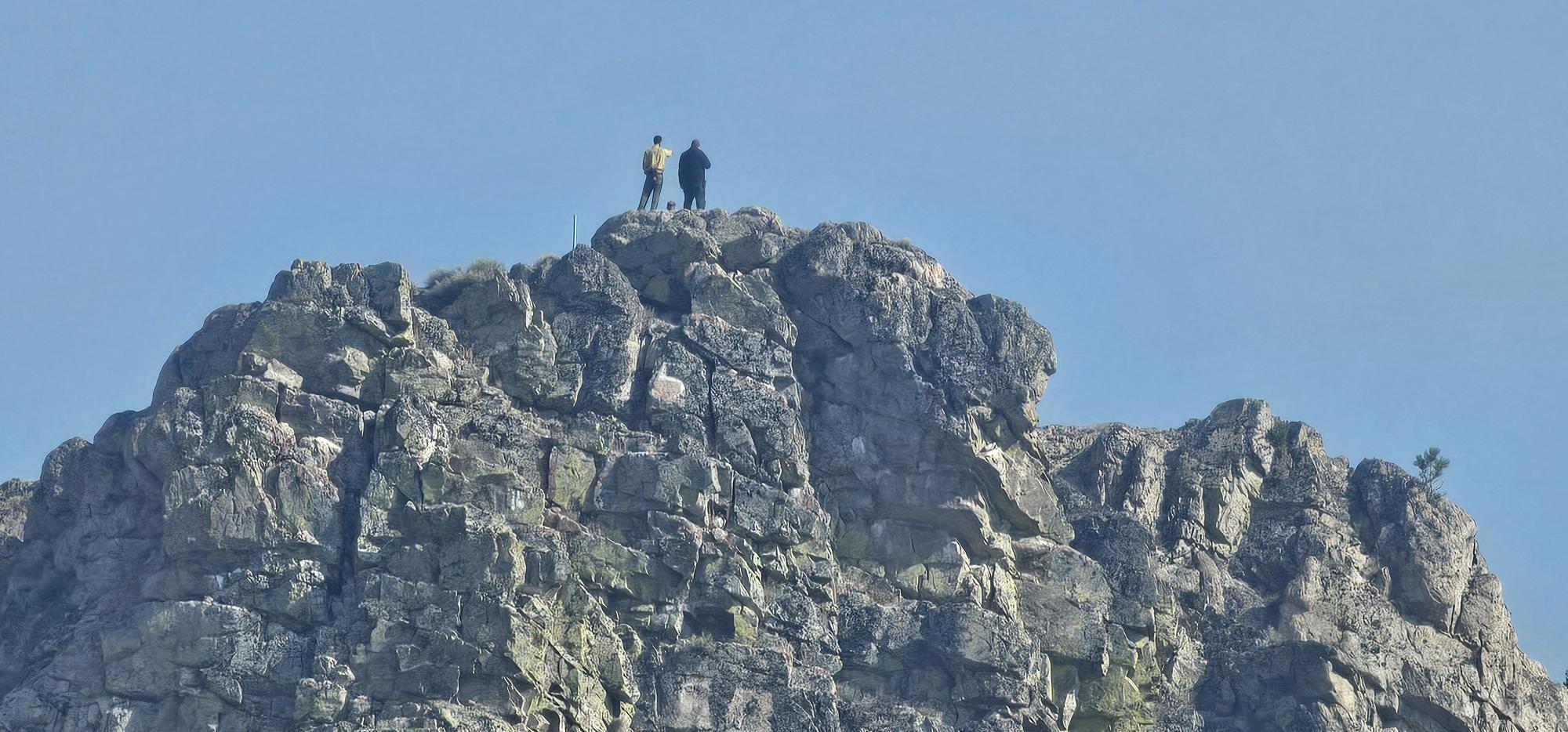 firefighters stand at top of overlook