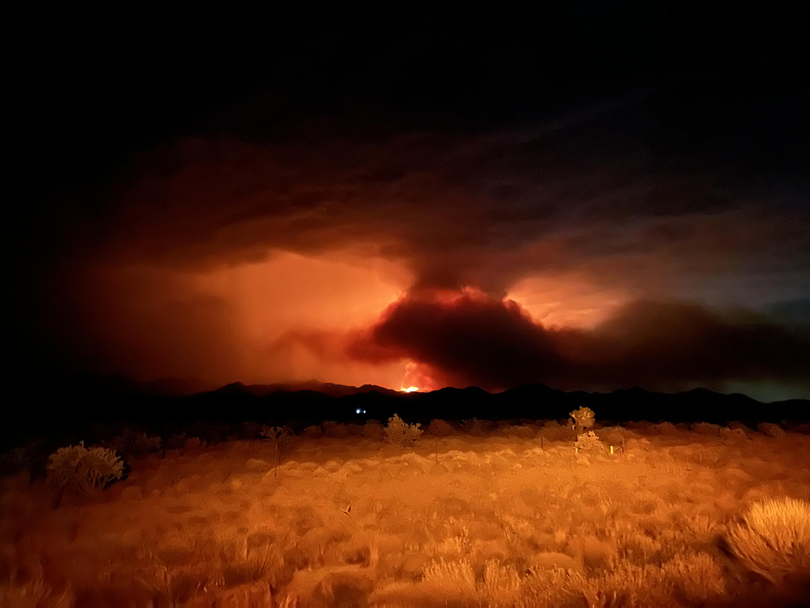 Distant view of Element Fire against nighttime skyline.