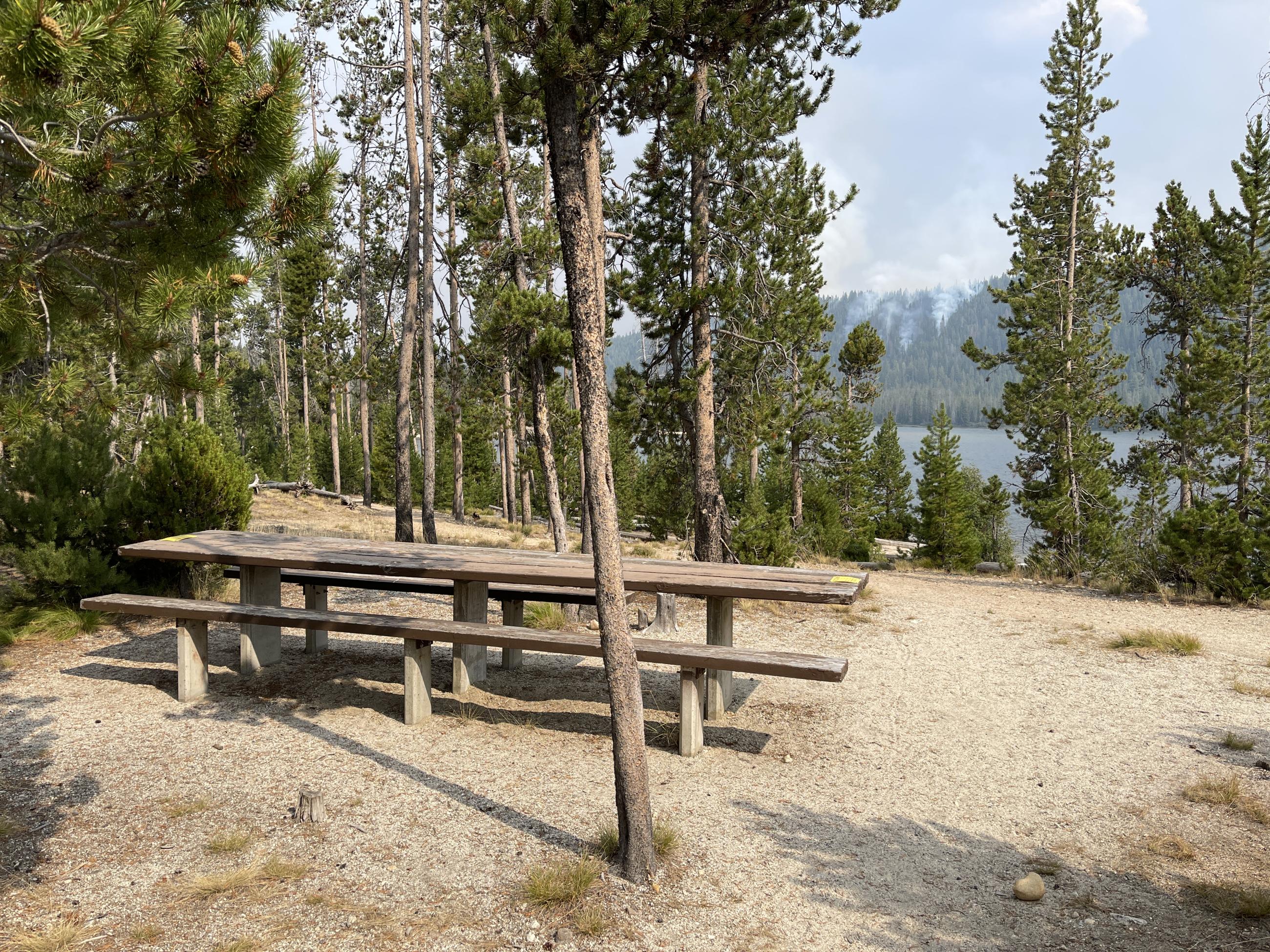 picnic table with green trees at stanley lake on Aug 25