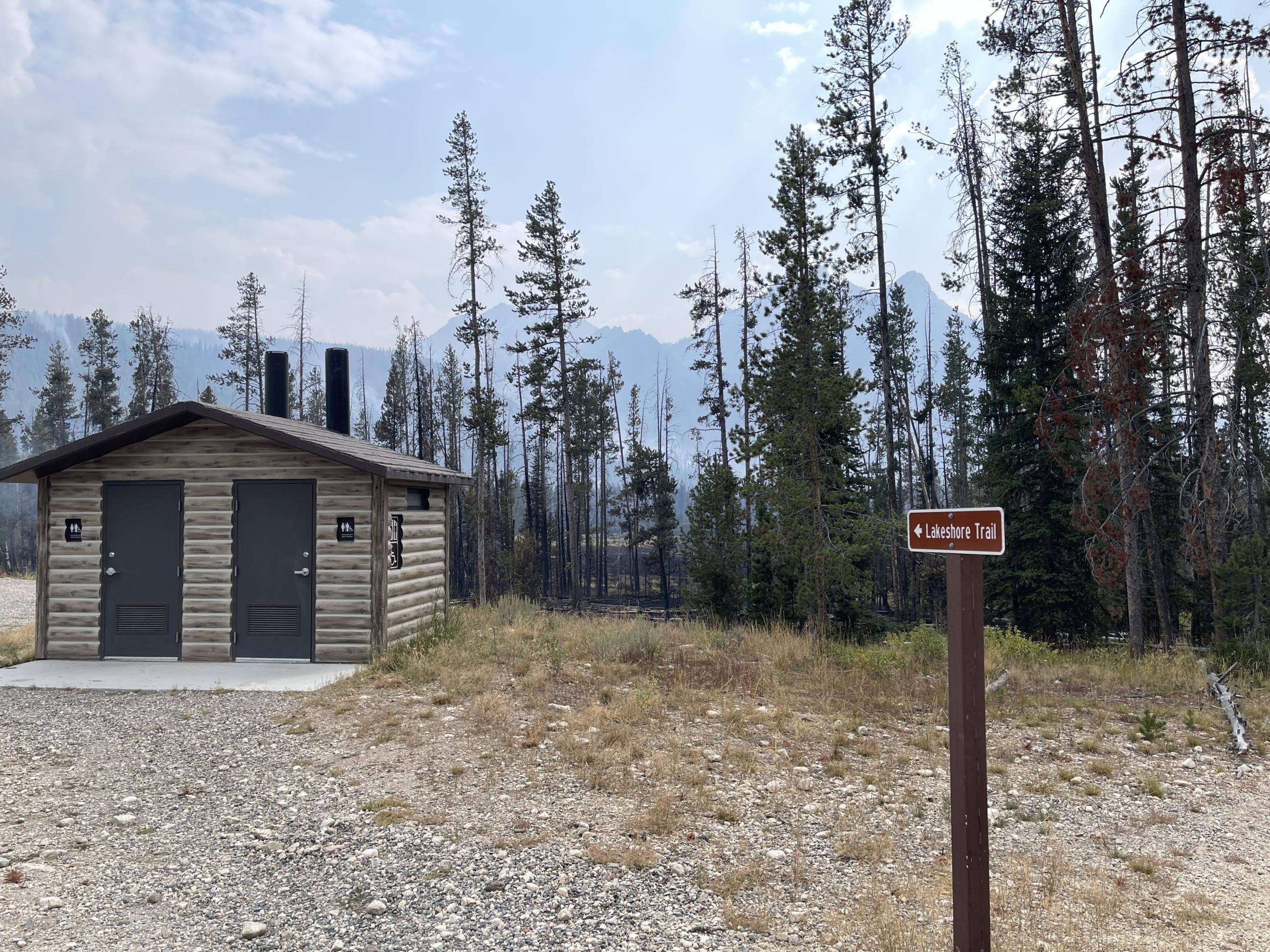 Restroom building at Stanley Lake with burned area behind it, aug 25