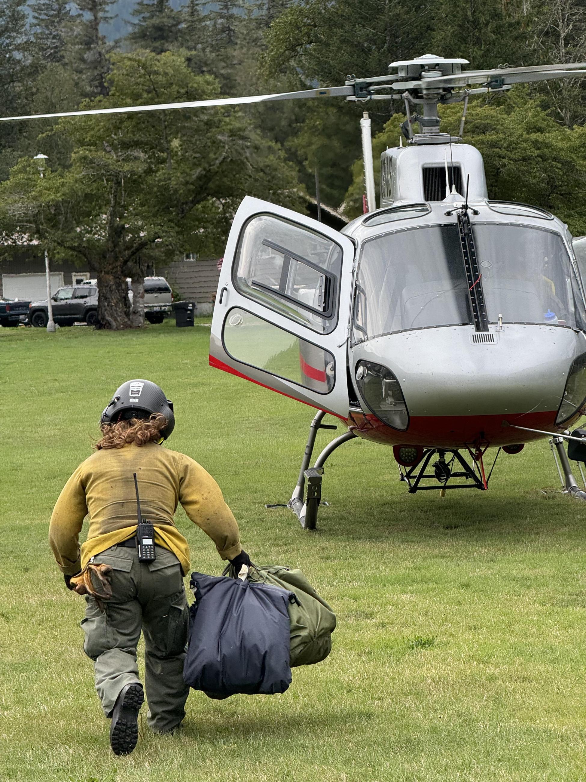 Helicopter crew member retrieves supplies for flight