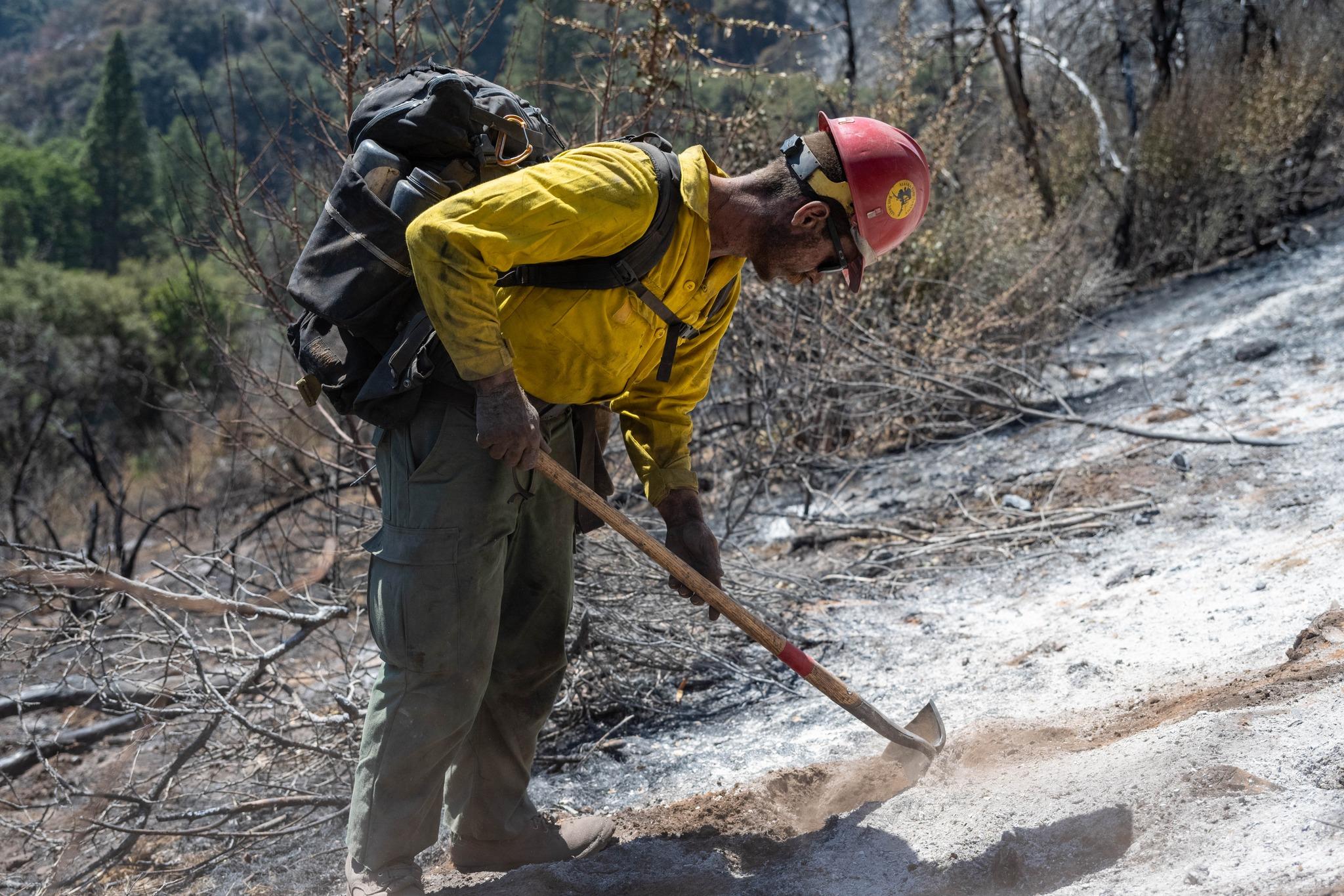 Firefighter with a tool