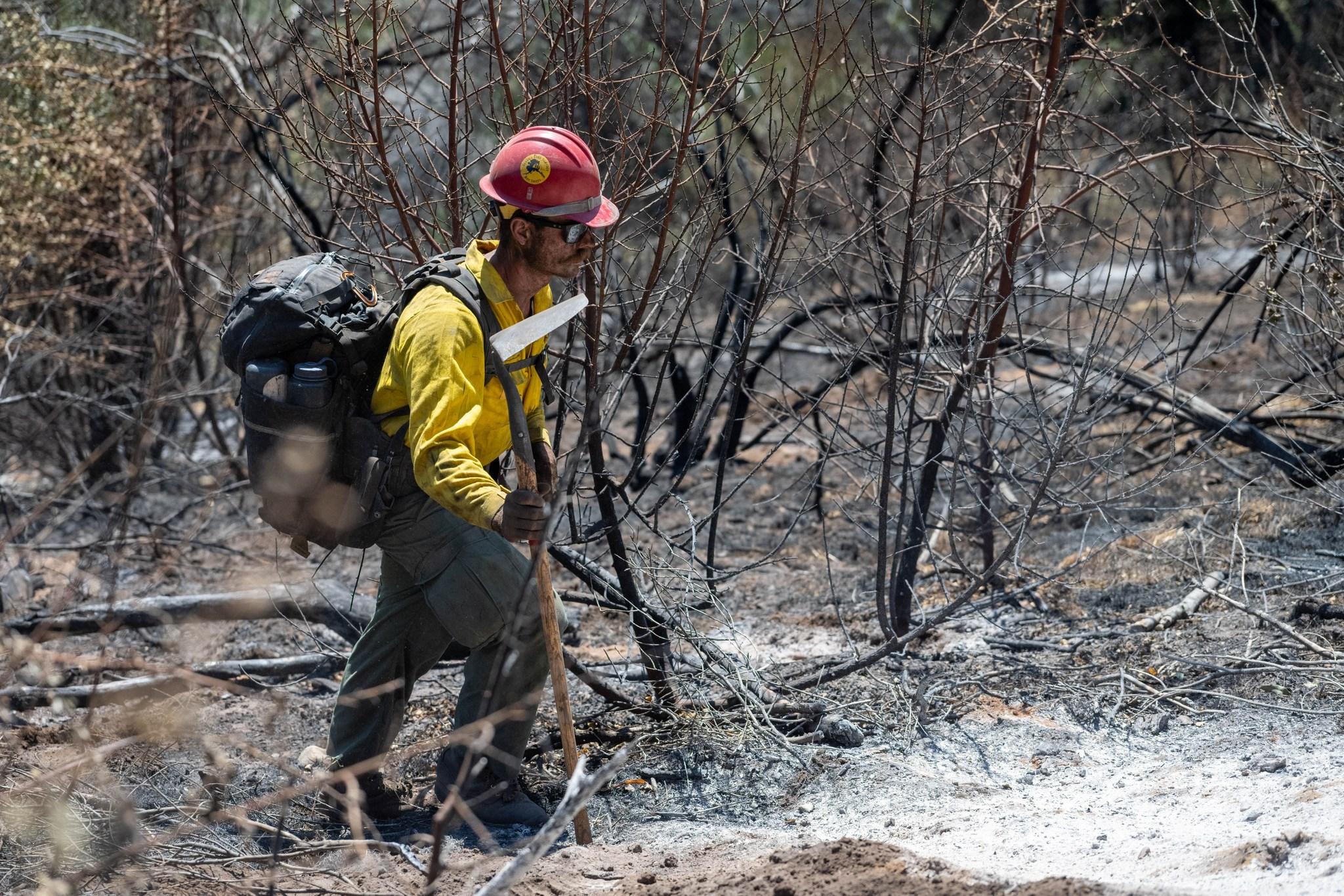 Firefighter with a tool