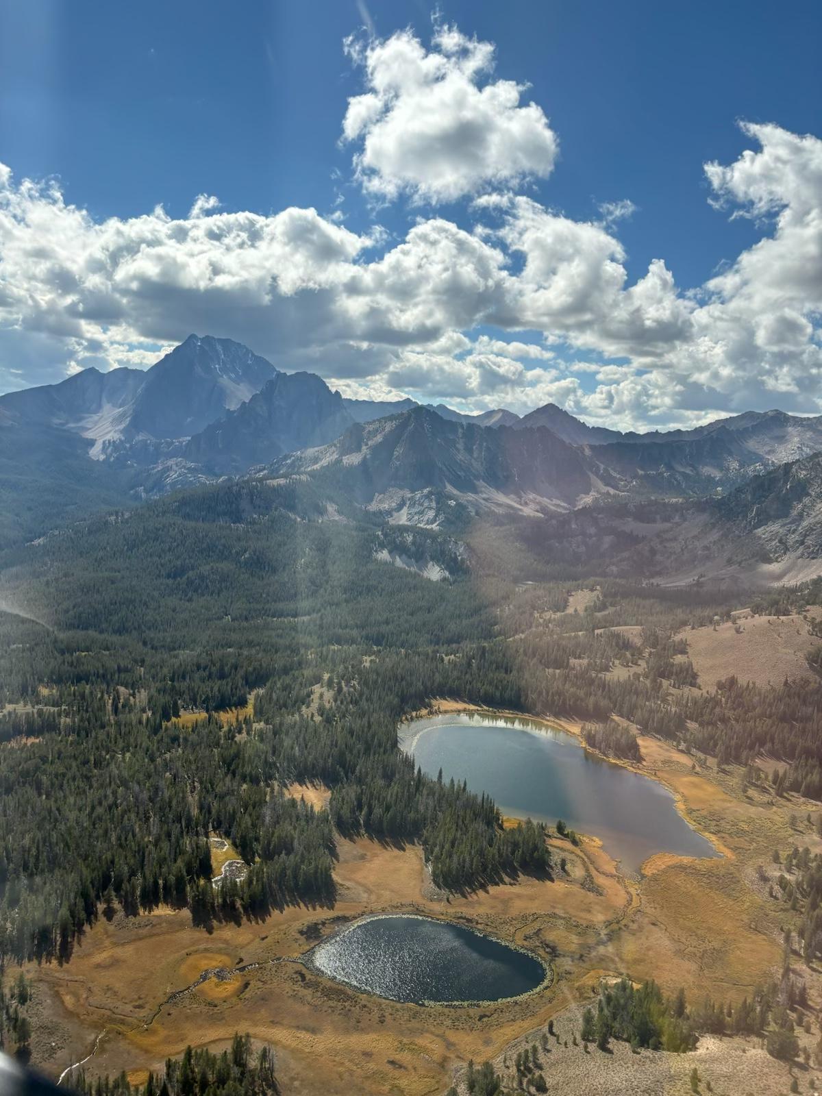 aerial view of two lakes with mountains in background