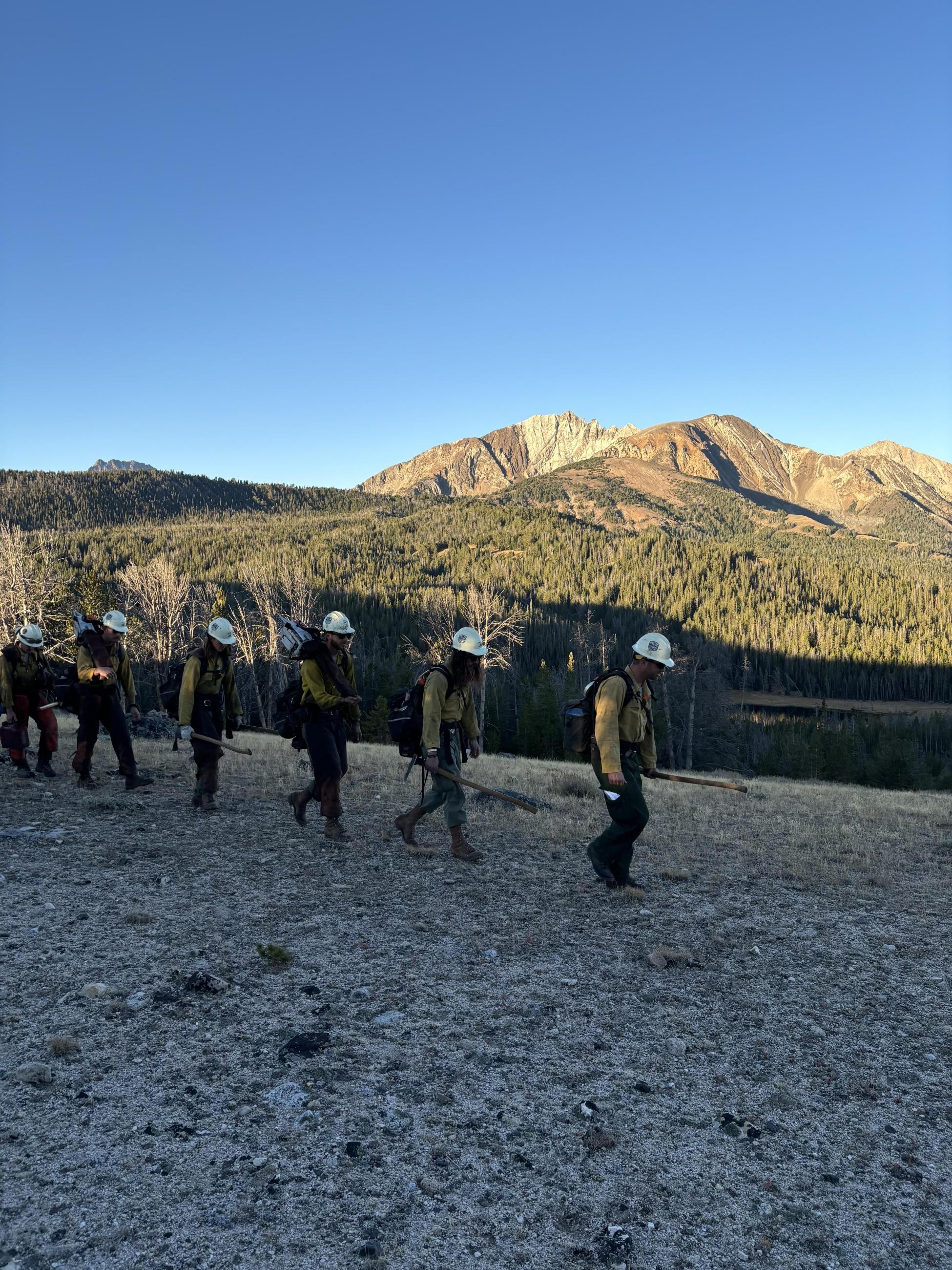 Firefighters hiking in a line to work on Frog Fire