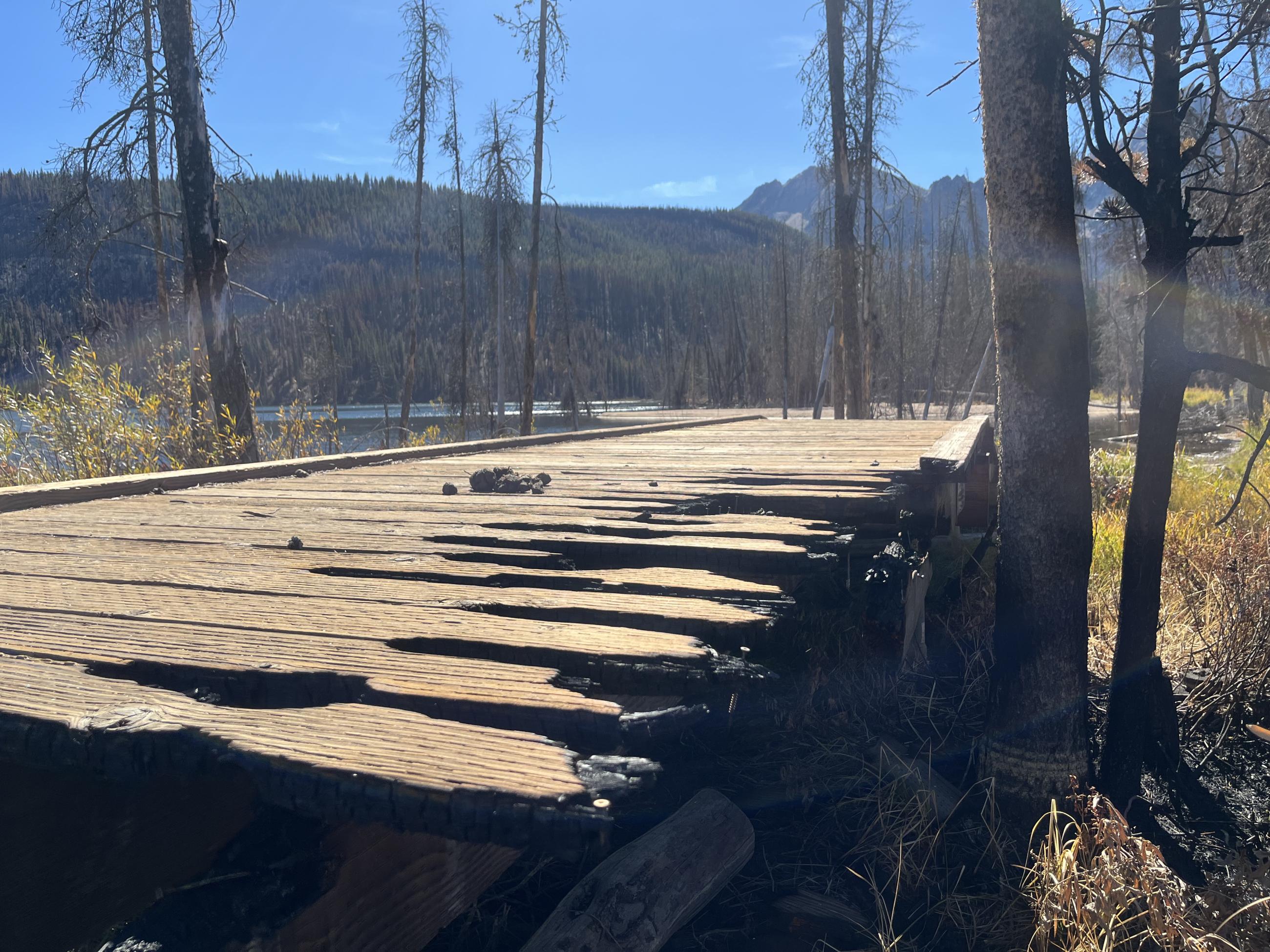 Burned boardwalk with Stanley Lake in the background