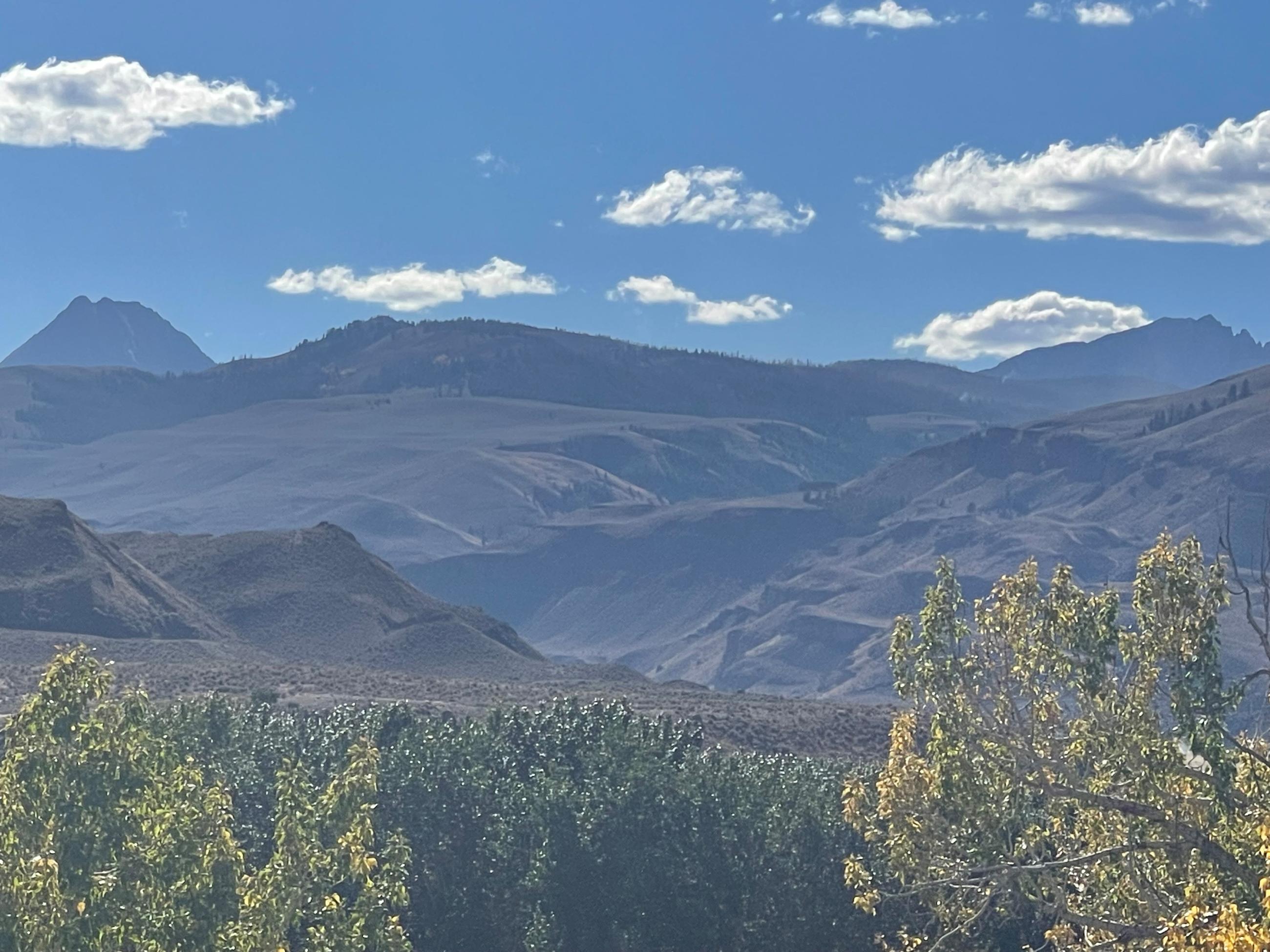 photo with mountains in background with a small puff of smoke