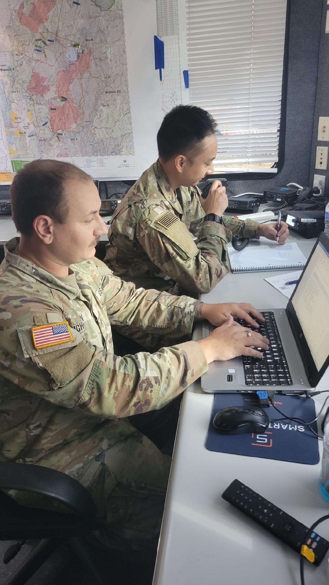 two soldiers work in the radio communications office 